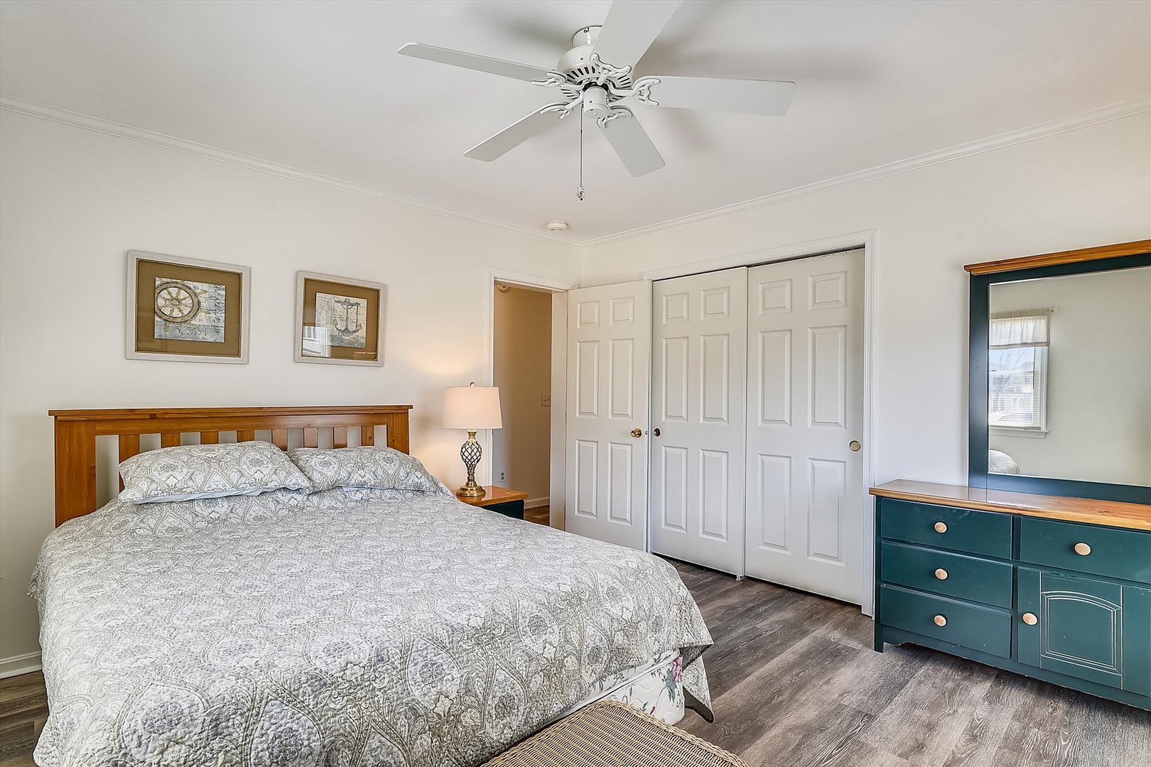 Drift off in this cozy bedroom with a welcoming ceiling fan, generous closet space, and charming coastal accents that make you feel right at home.