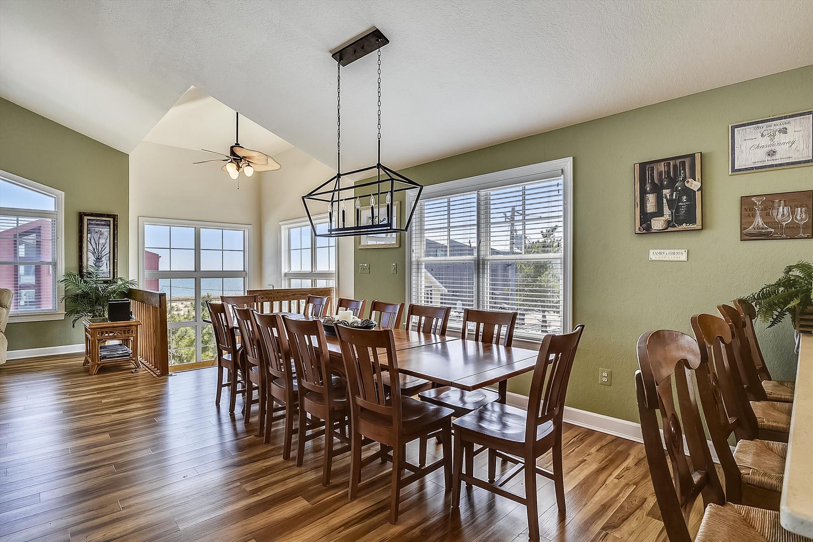 Gather your group around this beautiful dining table where warm wood tones, high ceilings, and abundant natural light create the perfect setting for memorable meals together.