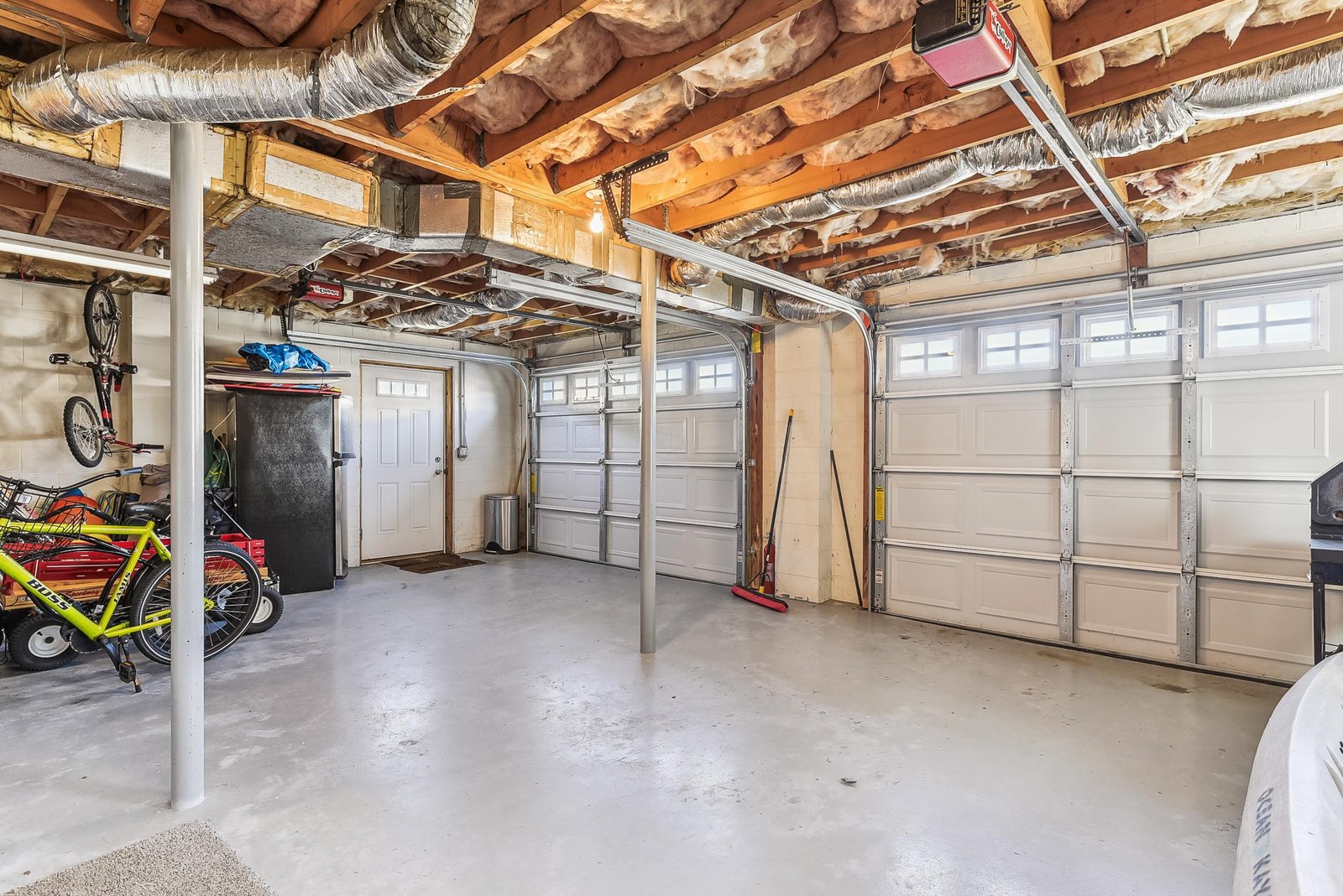 The spacious garage offers plenty of room for your vehicles and gear, with convenient storage racks overhead and extra space for your bikes and outdoor equipment.