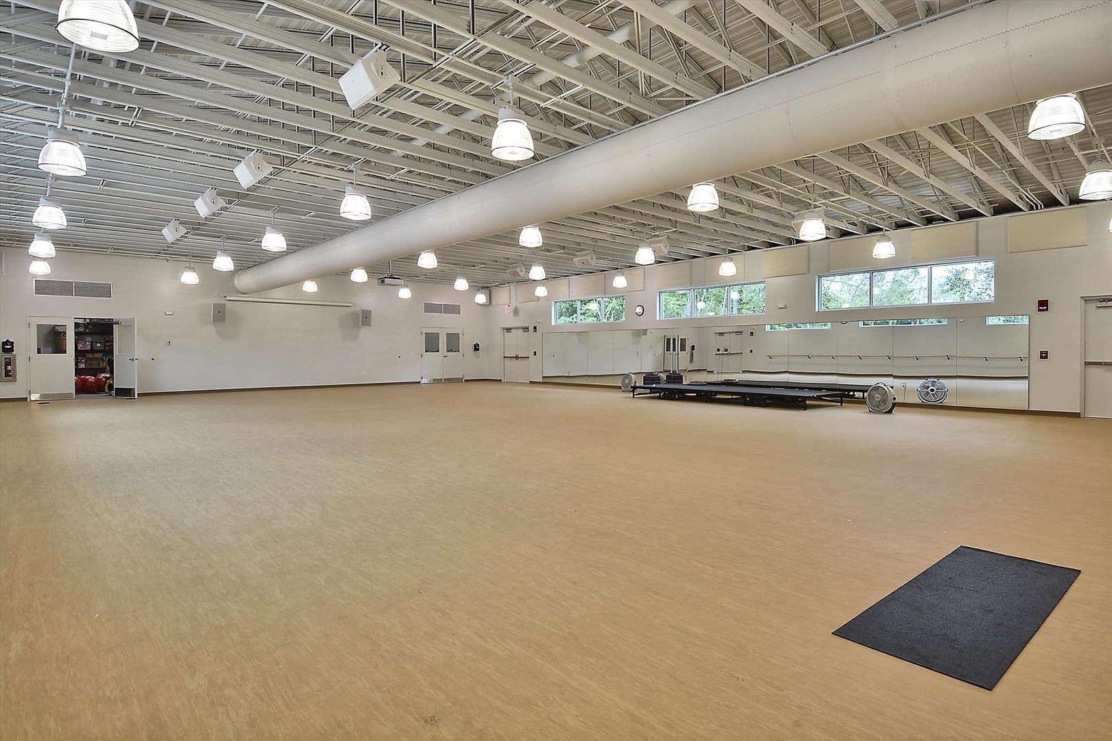 A spacious, bright studio awaits your group gatherings or fitness routines, with polished floors, abundant natural light, and plenty of room to move freely.