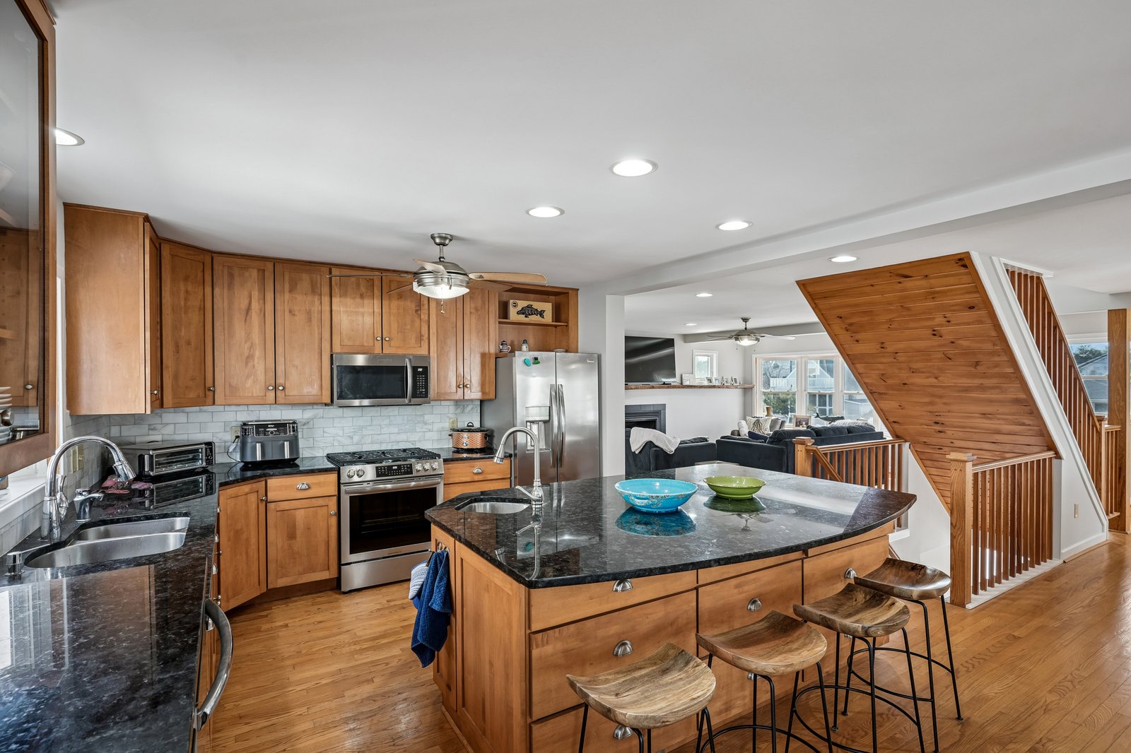 Your fully equipped kitchen features granite counters and island seating, perfect for preparing meals together.