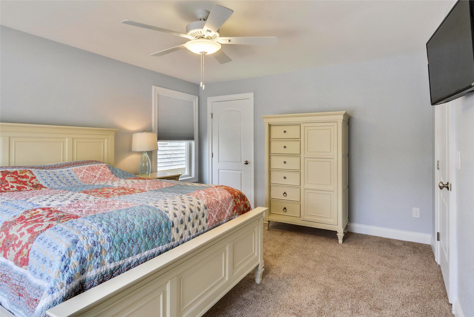 Unwind in your cozy bedroom with a ceiling fan overhead, soft lighting, and comfortable furnishings that make relaxation effortless.