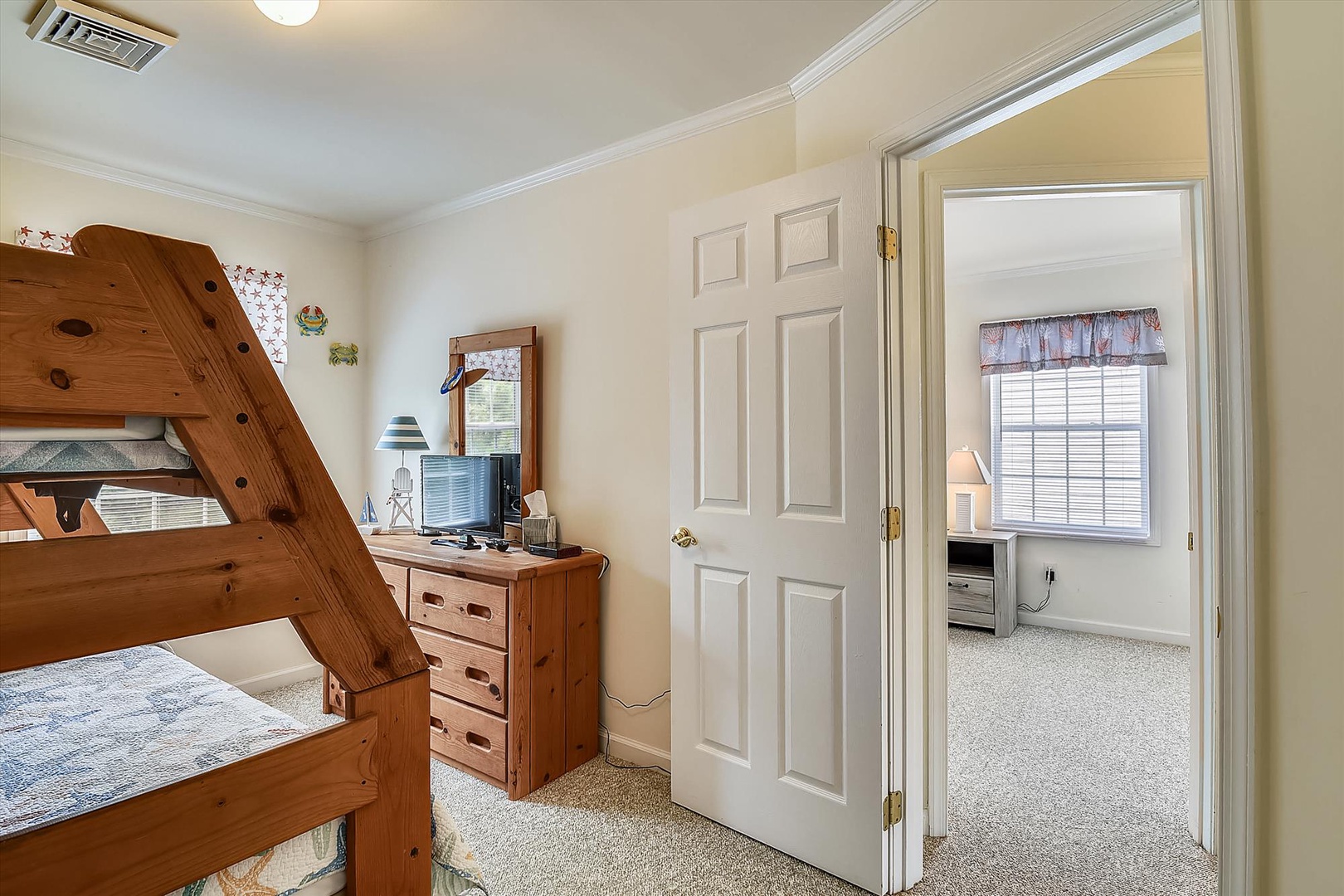 Your kids will love the cozy bunk beds and cheerful decor, while you'll appreciate the separate sleeping space just next door—perfect for families seeking comfort and flexibility.