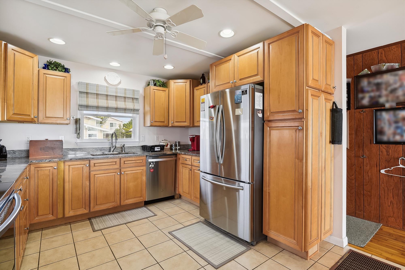 Your fully equipped kitchen features warm wood cabinetry, stainless steel appliances, and plenty of counter space for preparing meals together during your stay.
