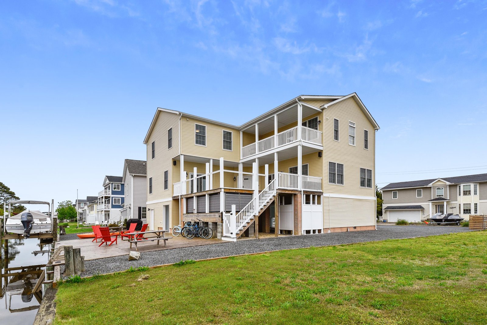 This waterfront vacation home sits in a peaceful neighborhood, featuring spacious balconies and direct access to the water for boating and kayaking adventures.