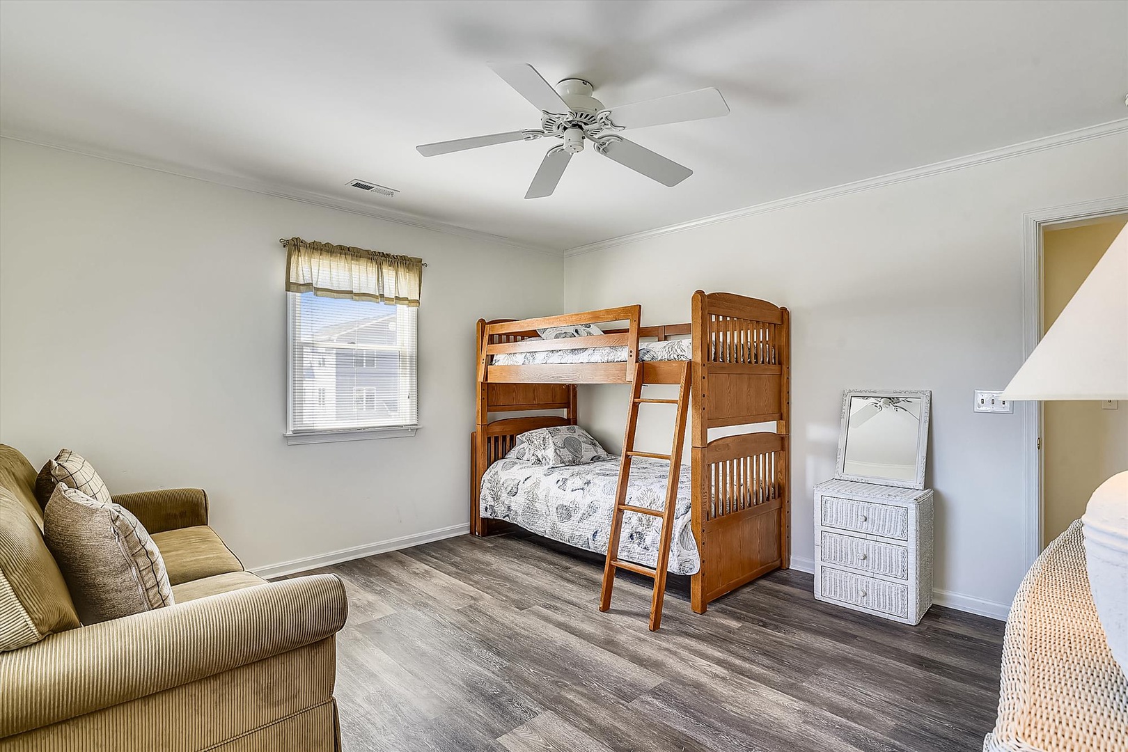 Your kids will love the cozy bunk beds in this bright bedroom, complete with a comfy sofa for lounging and reading together. The ceiling fan keeps the room cool and comfortable.