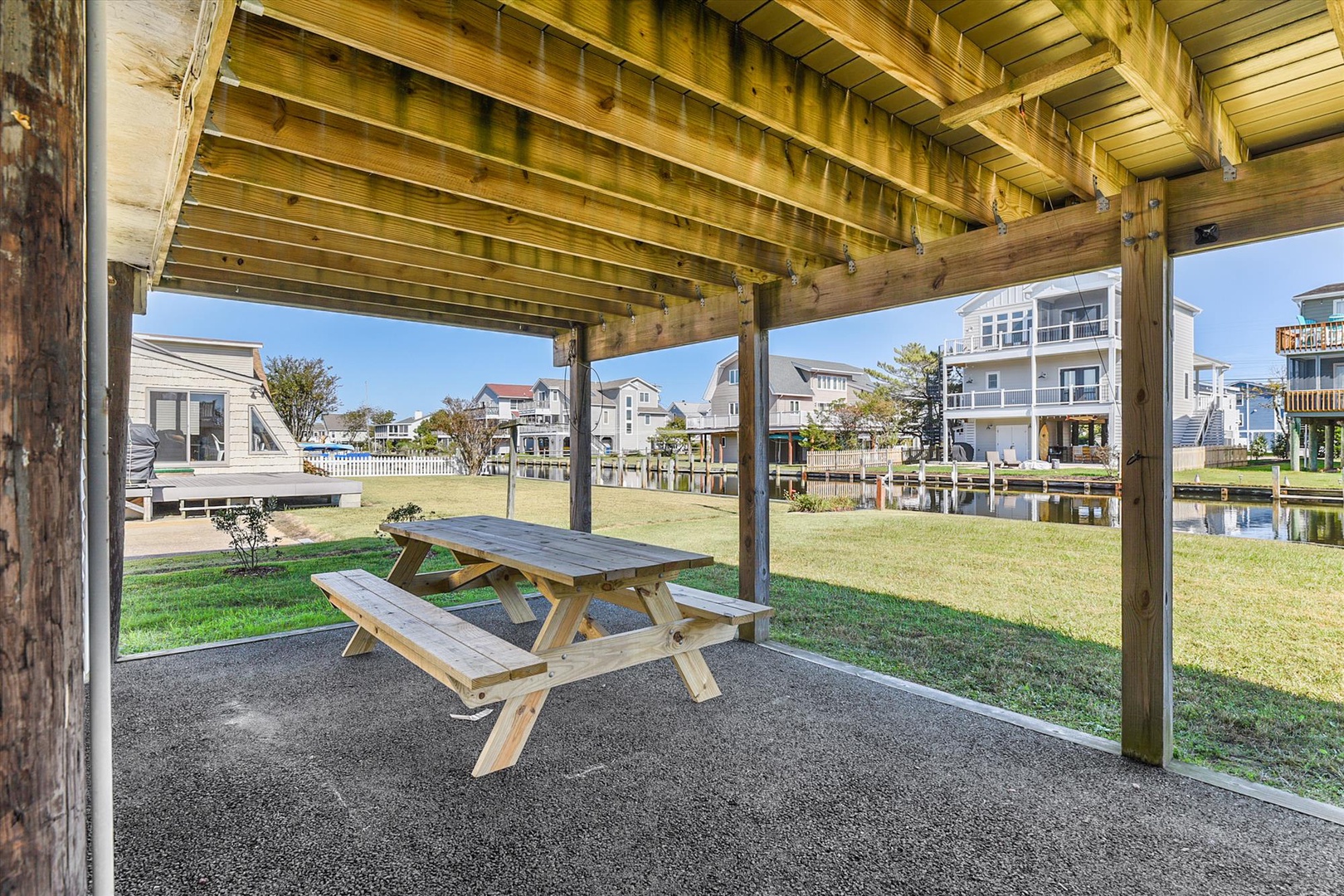 Gather around your private picnic table under the shaded pavilion, where you can enjoy meals or morning coffee overlooking the peaceful canal and neighborhood beyond.