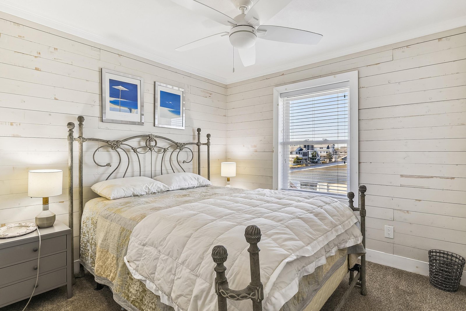 Slip into your cozy bed and let the ceiling fan's gentle breeze lull you to rest. The soft nightstand lamps create a warm, inviting glow perfect for winding down after a day at the beach.