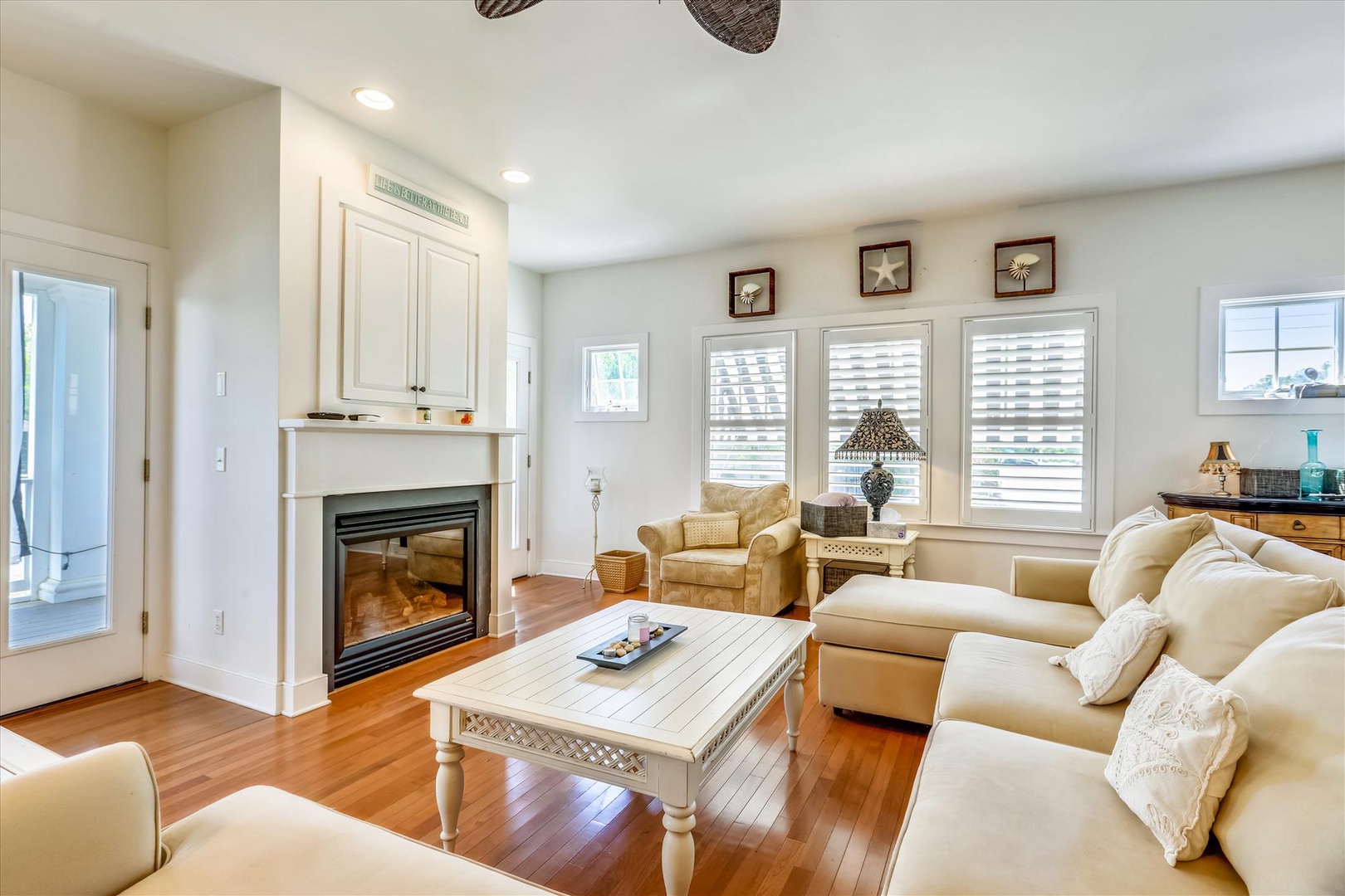 Sink into the plush sofas and feel right at home. Warm hardwood floors, a cozy fireplace, and charming coastal decor create your perfect retreat.