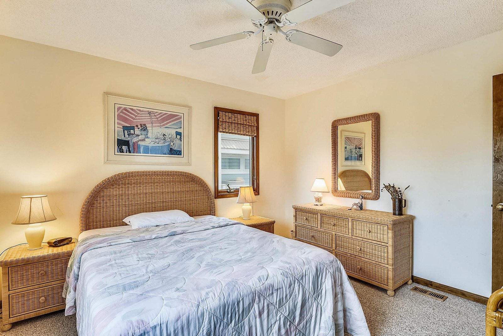 Sink into this cozy bedroom with its plush bed and breezy ceiling fan—your perfect retreat after a day of coastal adventures.