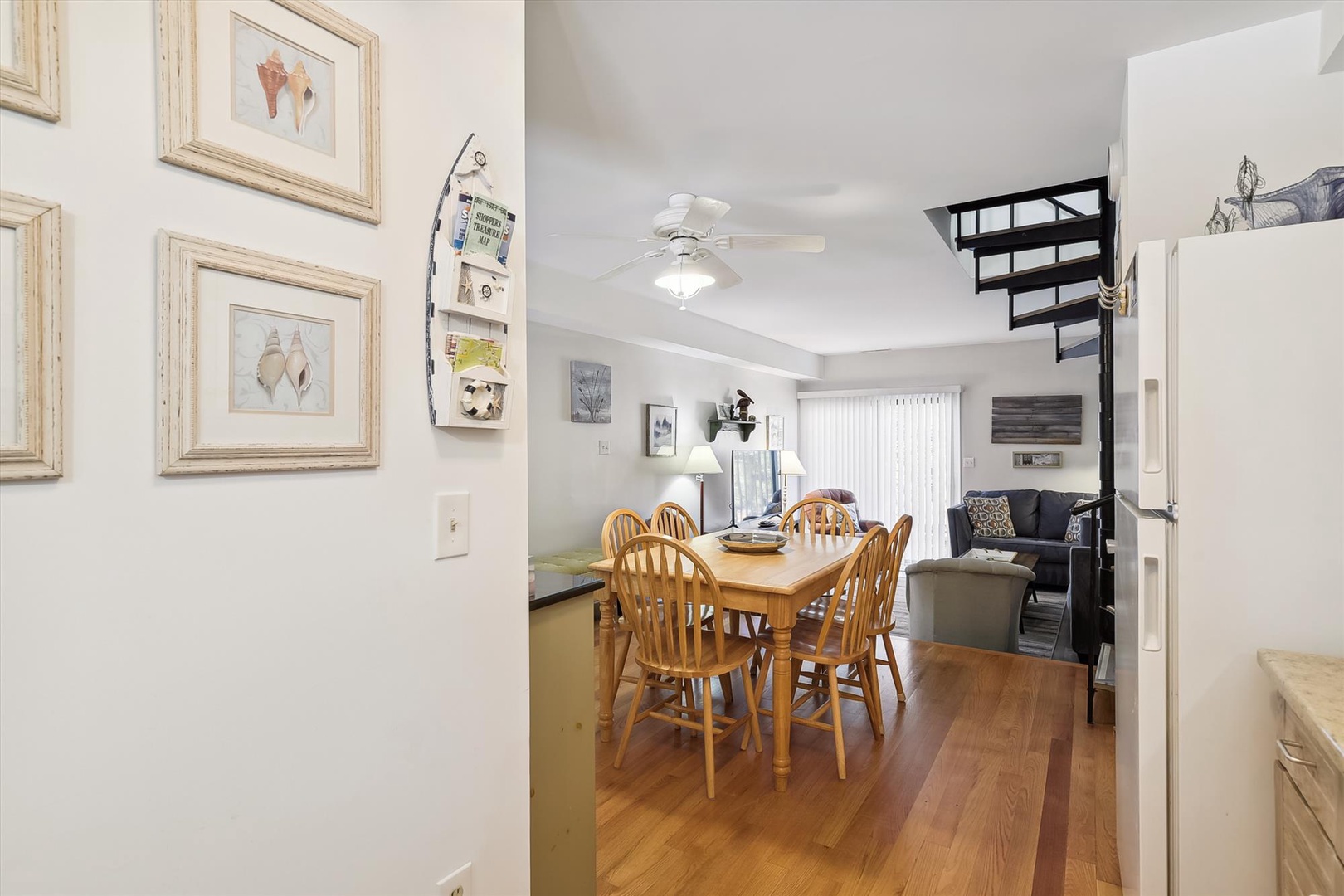 Step into your inviting open-concept space where a cozy dining table invites you to gather for meals, while the lofted bedroom above and comfortable living area beyond create a relaxing home-away-from-home atmosphere.