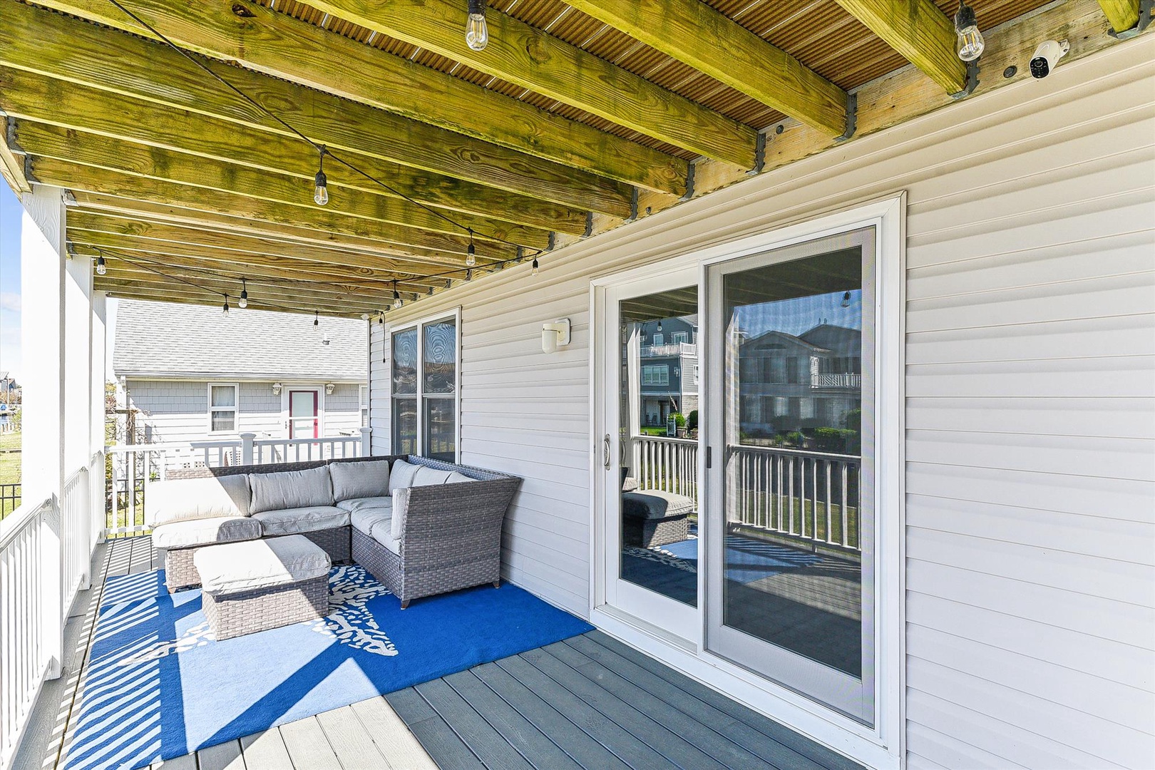 Step onto your covered patio where comfortable lounge seating invites you to unwind and enjoy the fresh air in this peaceful, sheltered outdoor retreat.