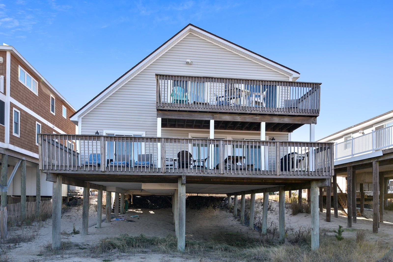 A beachfront property built on sturdy pilings with dual-level decks overlooking the sand and ocean—your coastal retreat awaits just steps from the shore.
