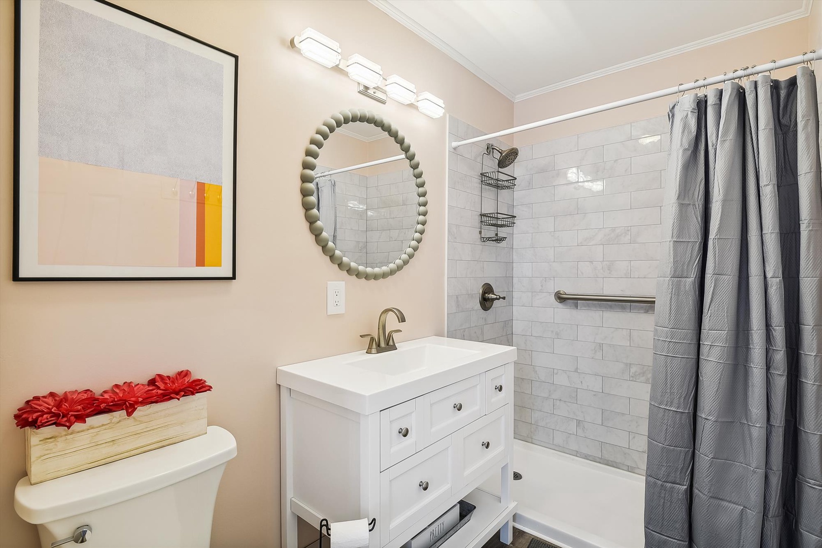 Refresh in your tastefully designed bathroom featuring a sleek vanity, walk-in shower with safety grab bar, and soft towels ready for your arrival.