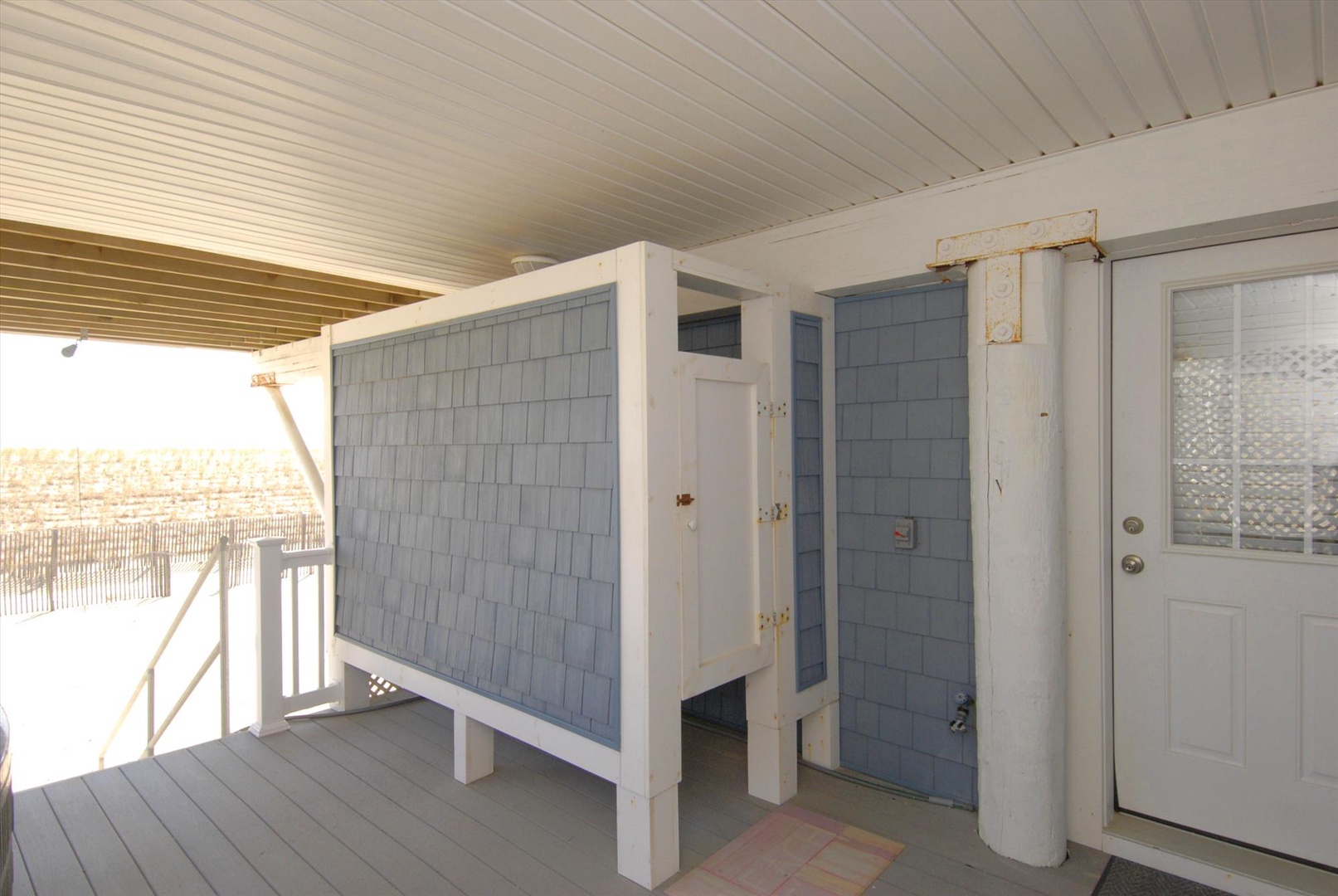 Private outdoor shower awaits after your beach days, offering refreshing rinses under the coastal sun with ocean breezes all around.