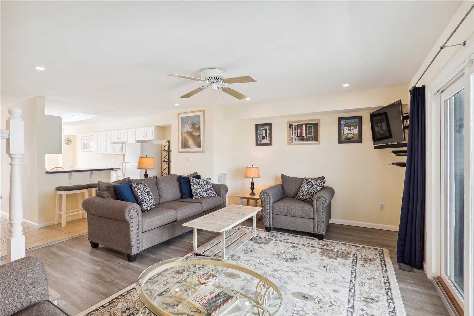 Sink into plush gray sofas and enjoy your favorite shows in this bright living space, where soft lighting and thoughtful decor make every evening feel like home.