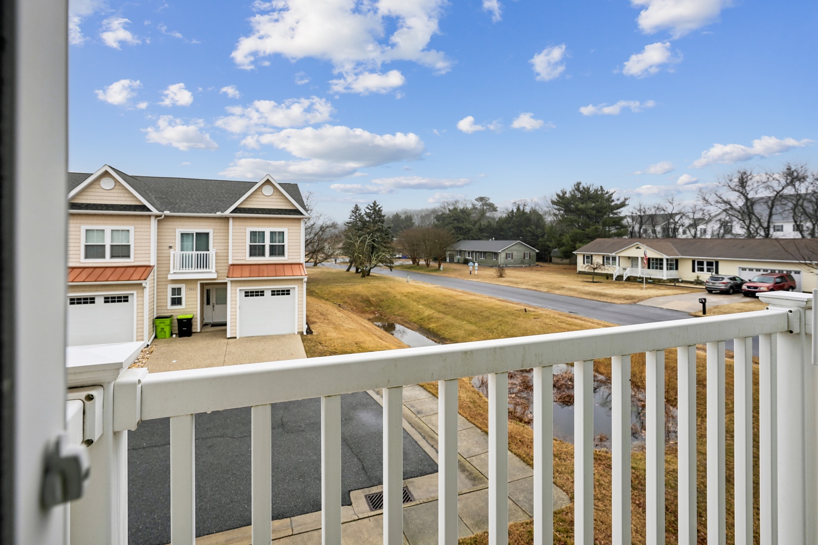 Peaceful residential neighborhood with well-maintained homes and quiet streets under a bright blue sky.