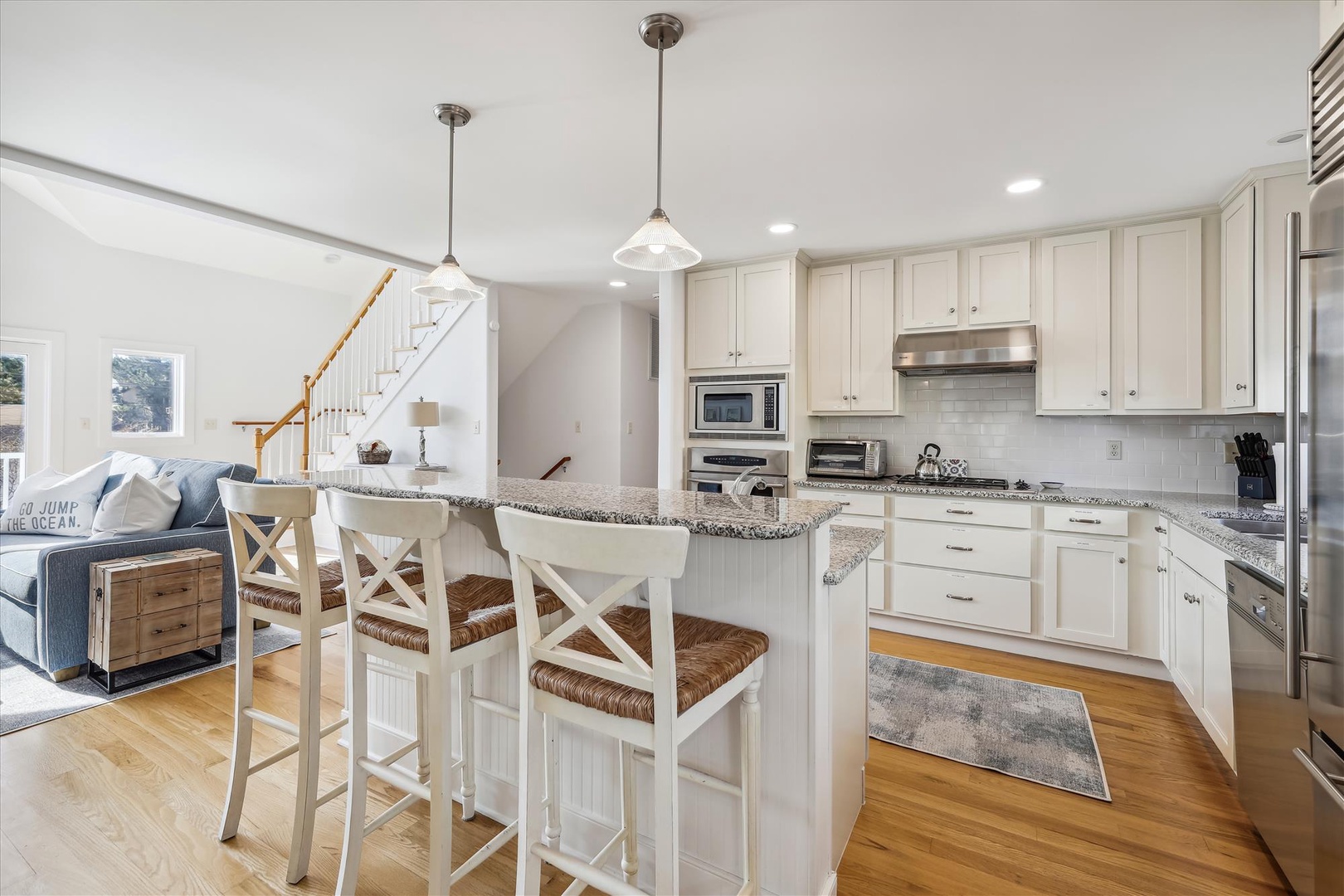Picture yourself preparing meals in this bright, coastal-inspired kitchen with granite countertops, stainless appliances, and a breakfast island perfect for morning coffee or evening conversations.