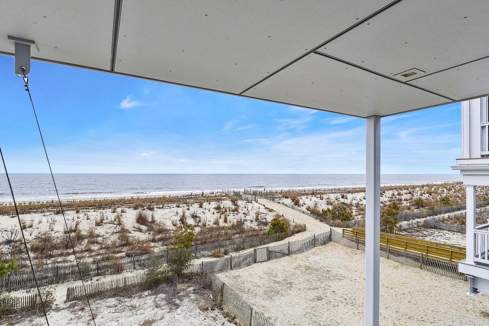This beachfront property offers direct access to the pristine shoreline and stunning panoramic views of the ocean from your covered patio—a perfect retreat for morning coffee and sunset gatherings.