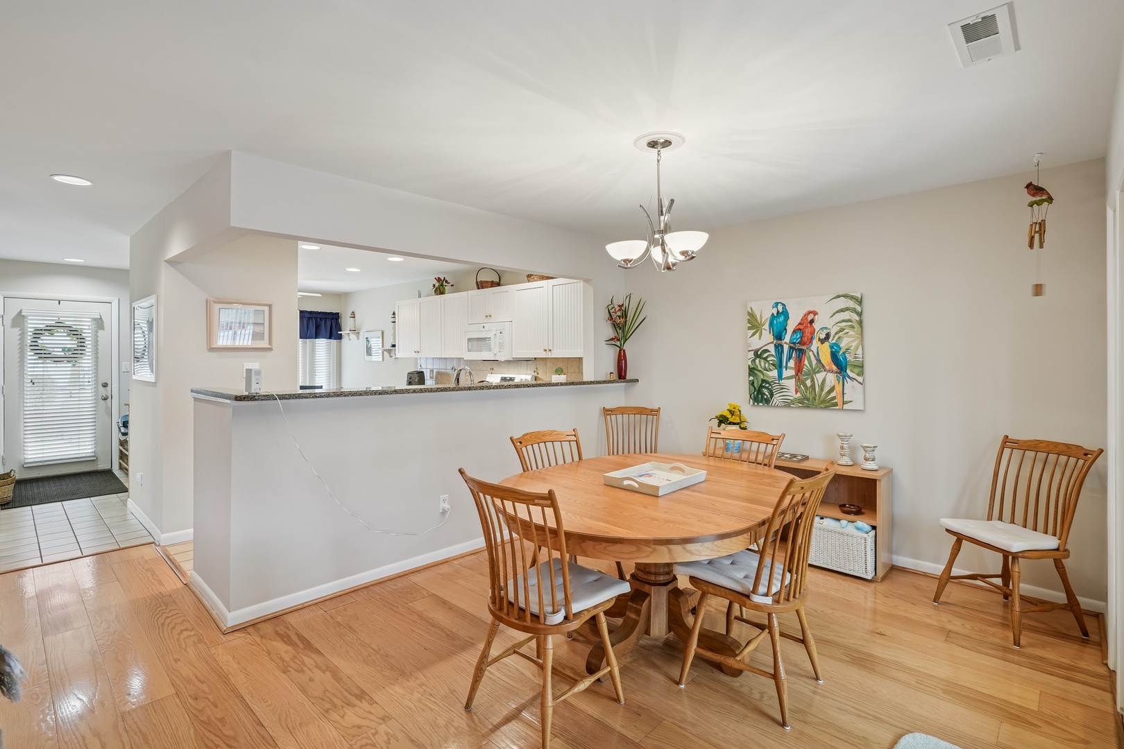 Gather around this welcoming dining table where your family meals become cherished memories in this bright, open-concept space.