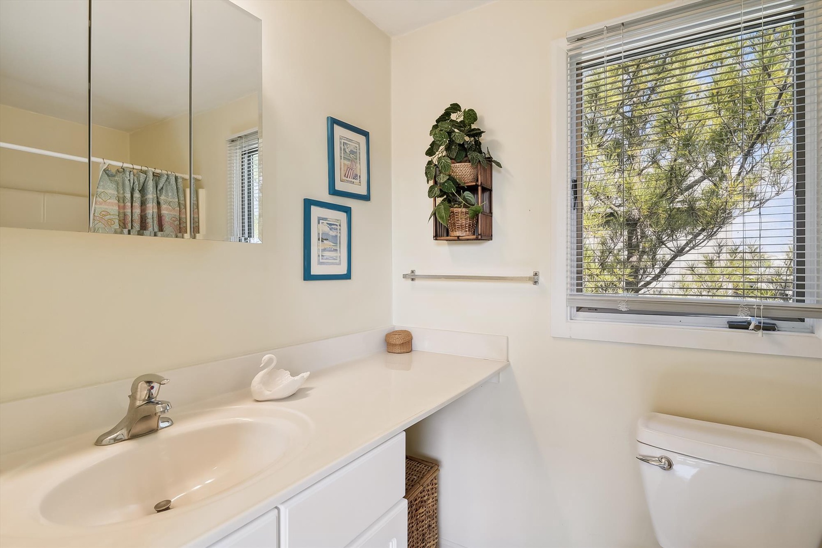 Your bright, clean bathroom features a peaceful view of greenery, perfect for a refreshing morning routine or unwinding after a day of exploration.