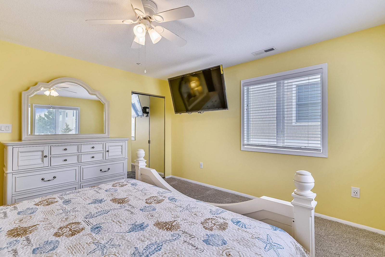 Unwind in your cheerful bedroom with a plush bed, stylish storage, and a ceiling fan to keep you comfortable after a day of adventure.