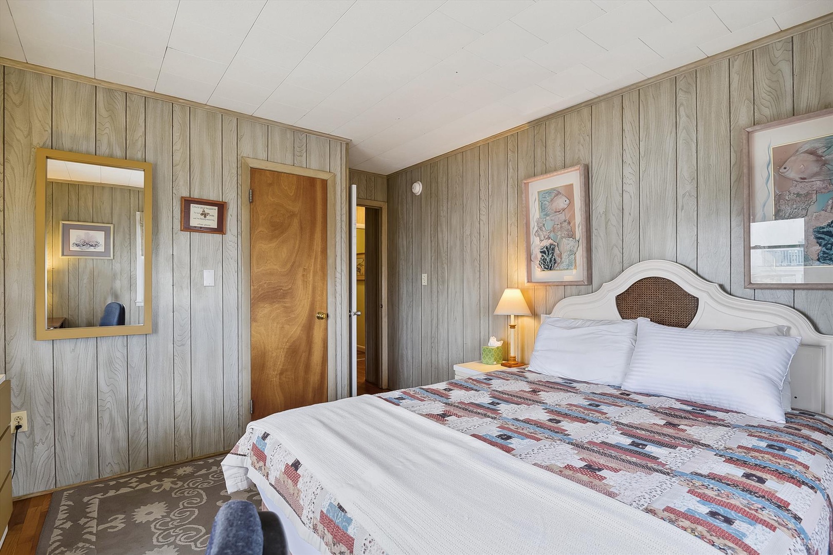 Sink into plush bedding and rustic coastal charm in your private bedroom, where soft lighting and thoughtful touches help you unwind after a day exploring.