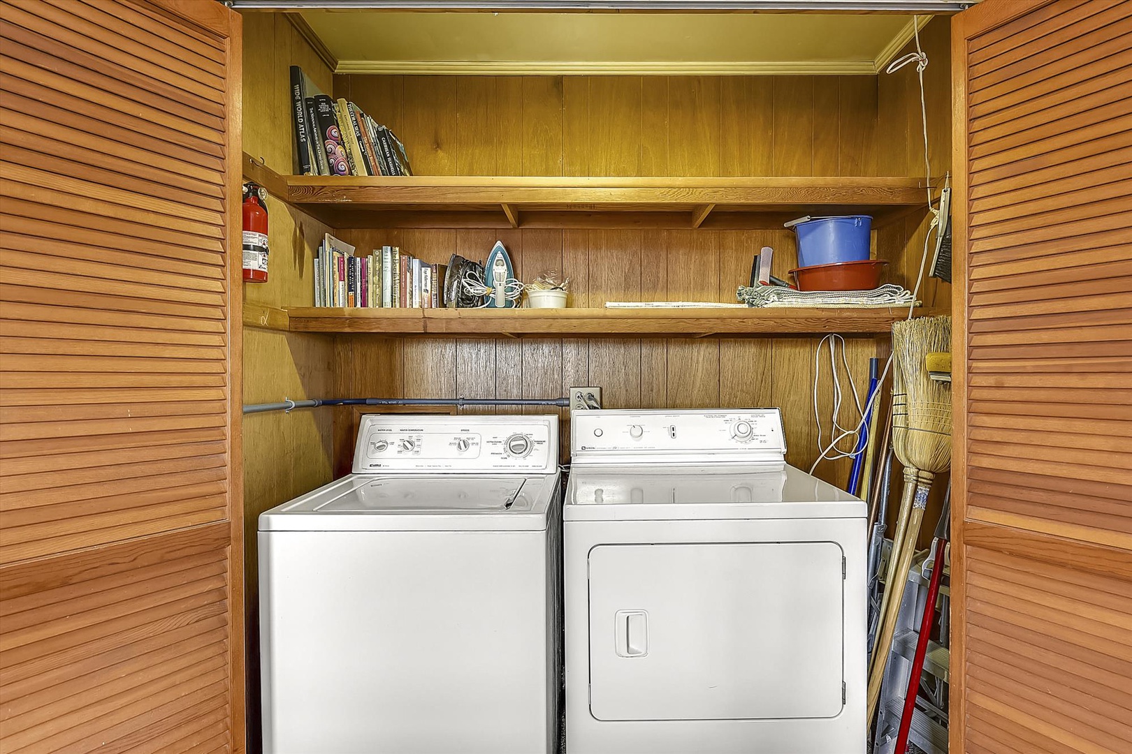 Full-sized washer and dryer at your fingertips, tucked into convenient built-in shelving with space for your essentials and storage above.
