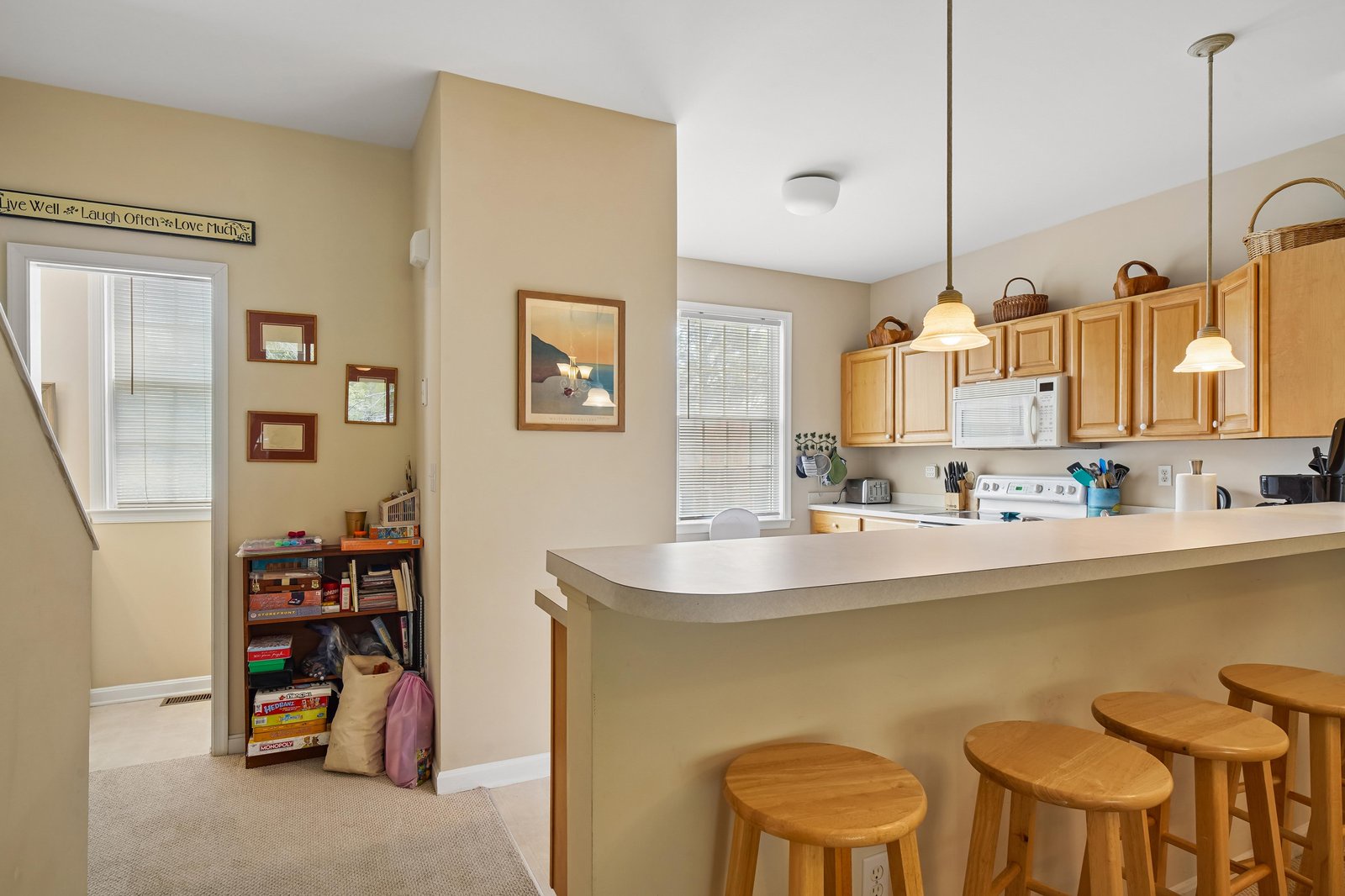 Gather around the breakfast bar for morning coffee or casual meals. Warm wood tones and ample natural light create a welcoming space where your group can connect.