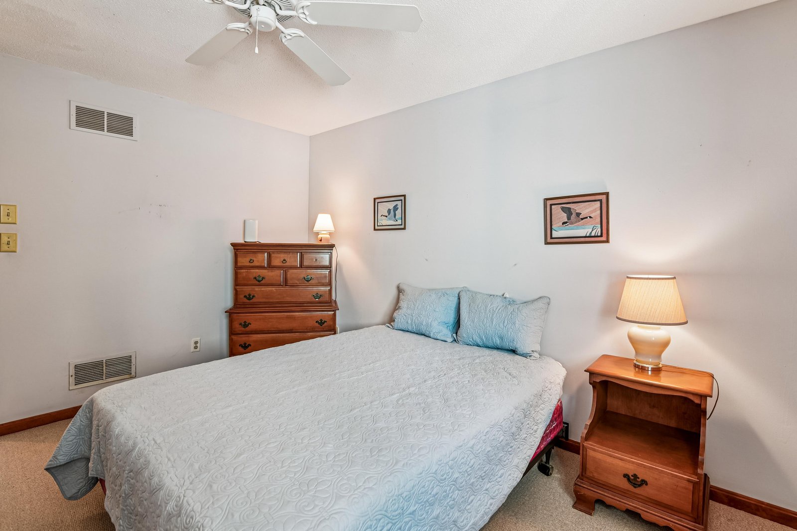 Unwind in your tranquil bedroom, where soft linens and classic wood furnishings create a restful retreat. The gentle ceiling fan ensures you'll sleep comfortably after a full day of adventure.