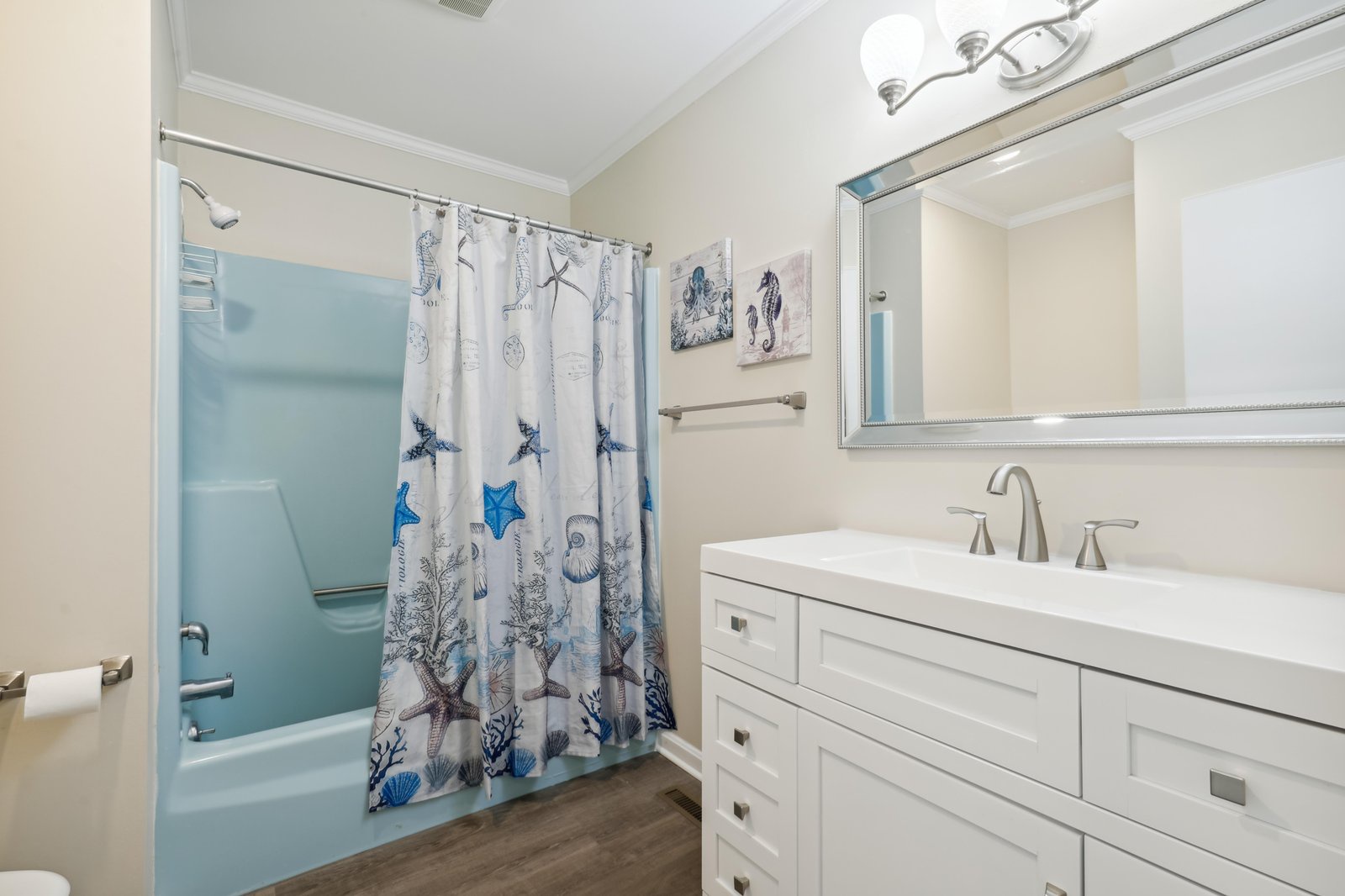 Freshen up in your bright, coastal-themed bathroom with a spacious tub-shower combo and ample vanity space for your belongings.