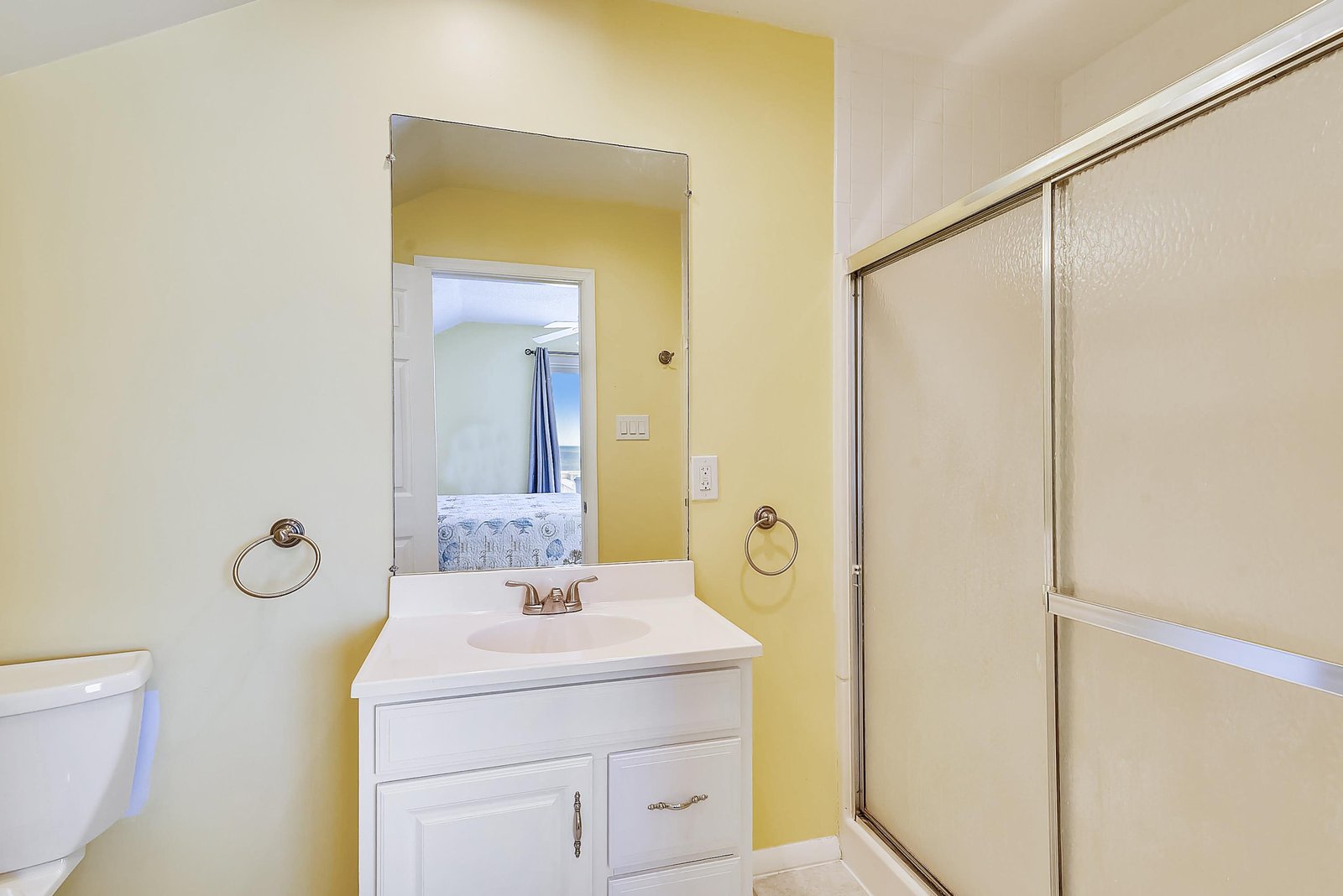 Your bright, cheerful bathroom is stocked with fresh towels and features a clean vanity, perfect for getting ready each morning.