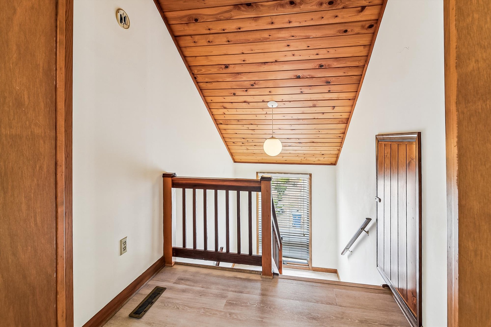 A charming loft space features vaulted wood plank ceilings and natural light, offering you a cozy nook perfect for relaxation or creative pursuits during your stay.