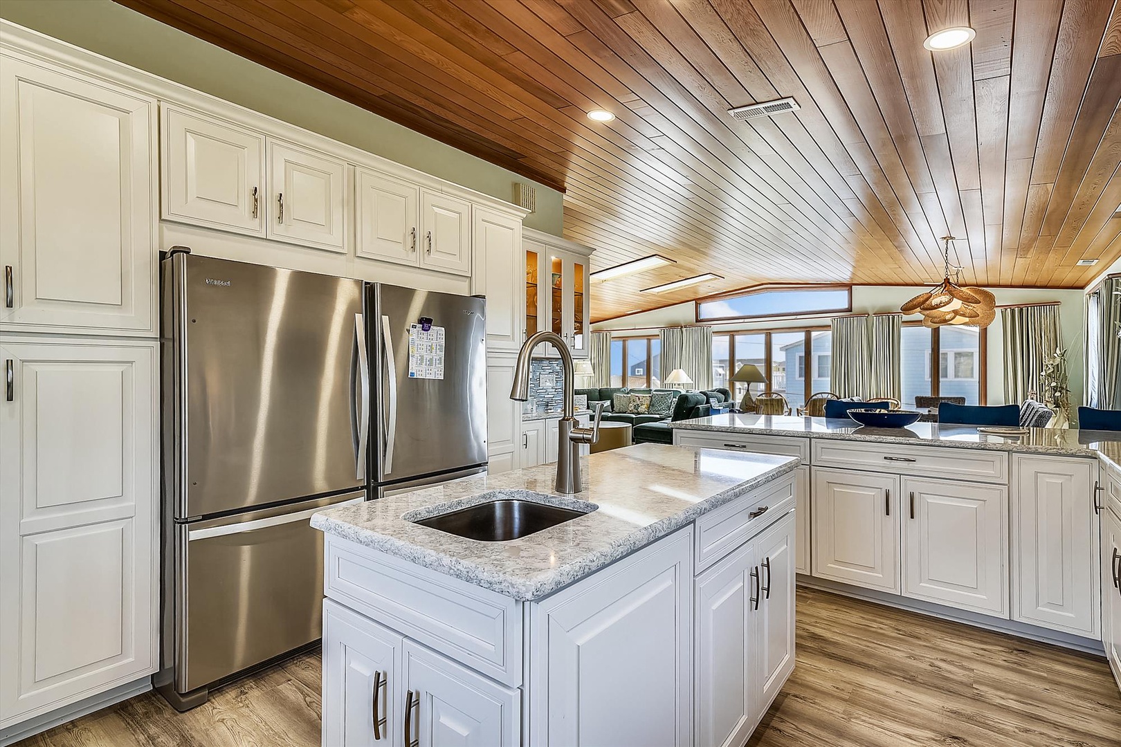 Picture yourself cooking in this bright, spacious kitchen with granite countertops, stainless steel appliances, and a handy island—your coastal retreat's culinary heart awaits.