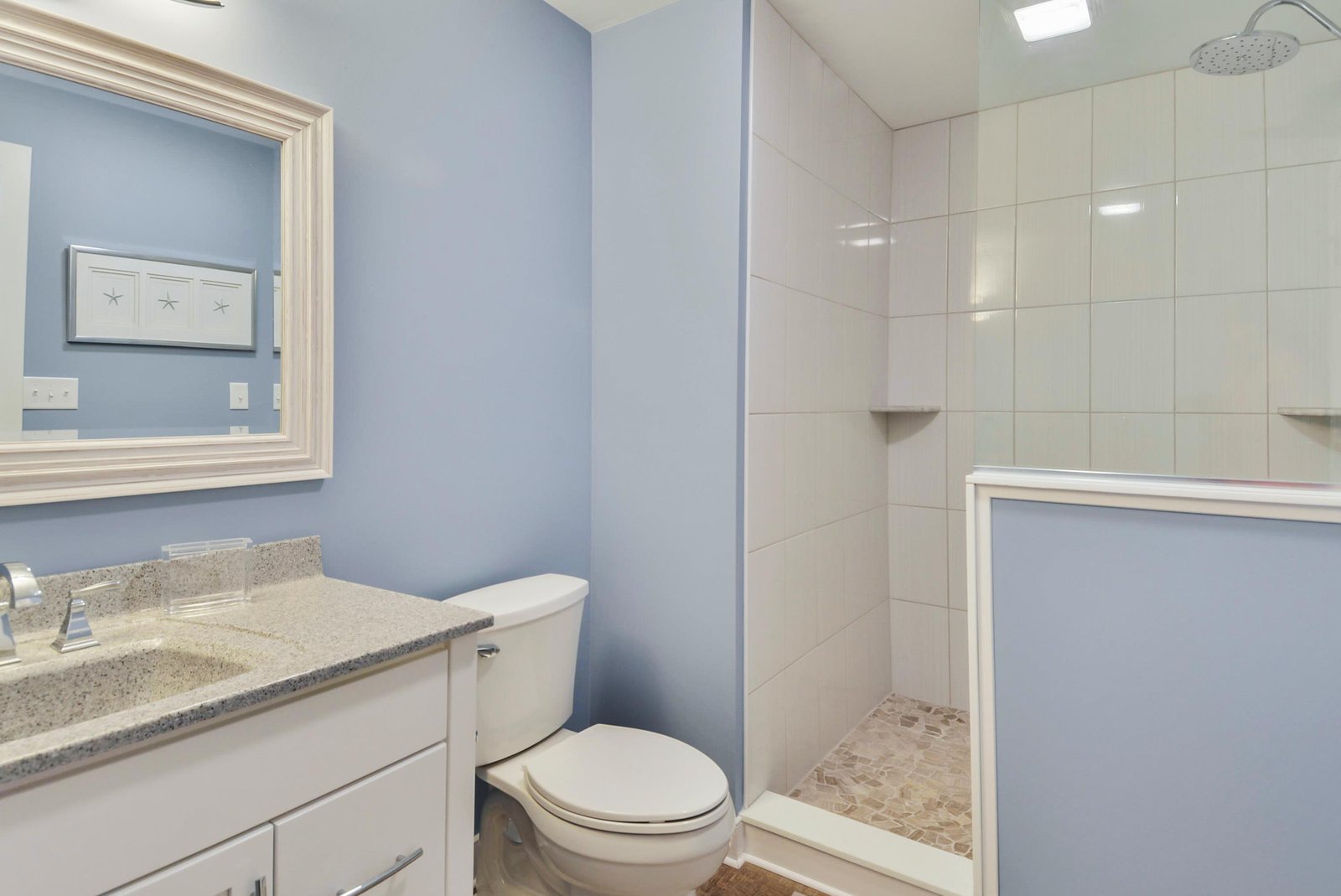 Step into your bright and spotless bathroom, where you'll find everything you need for a comfortable stay. The oversized shower and crisp blue walls create a relaxing, beachy vibe you'll love.