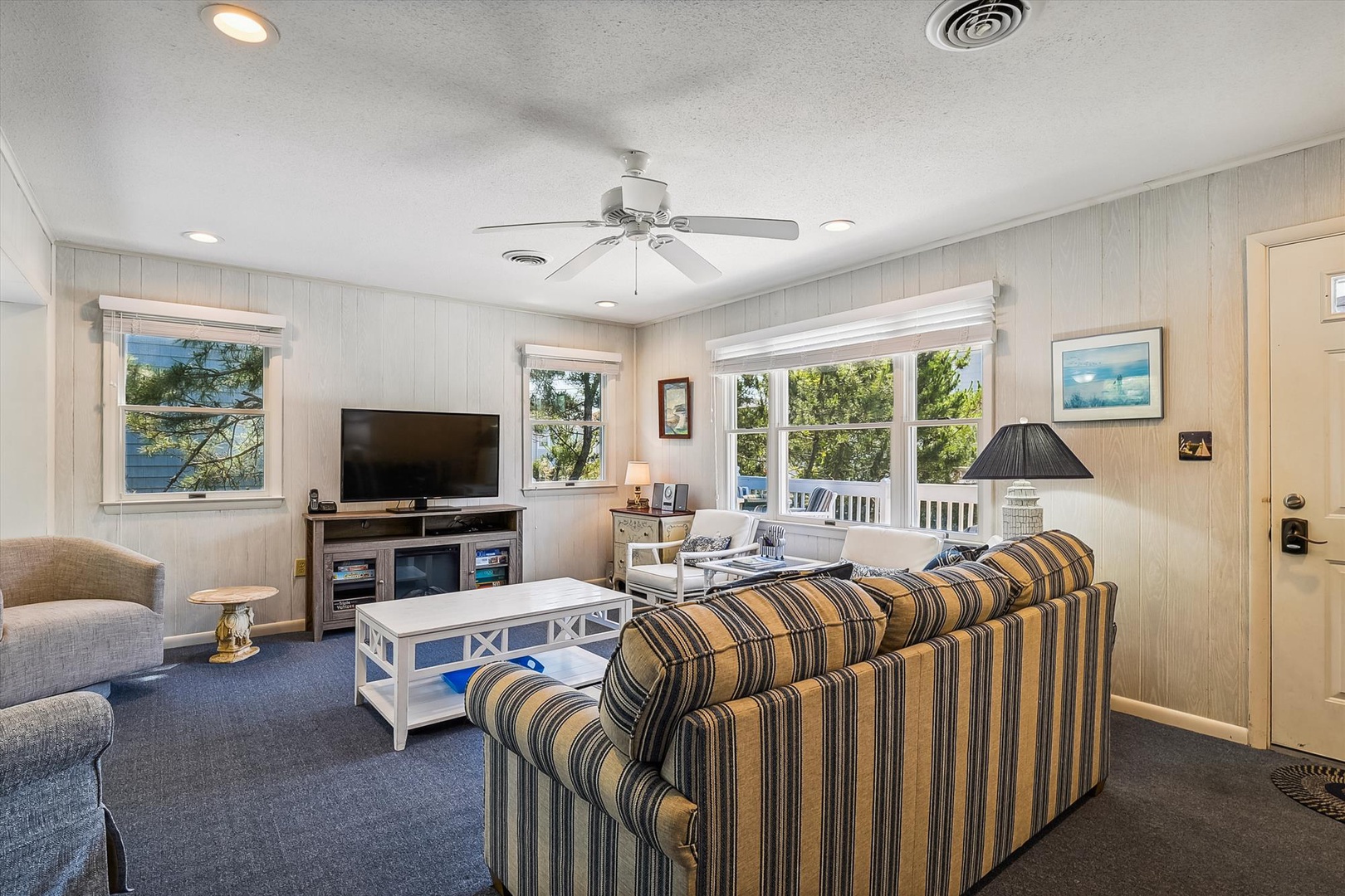 Sink into cozy seating in your bright, airy living room, where natural light pours through and peaceful lake views await just beyond your windows.