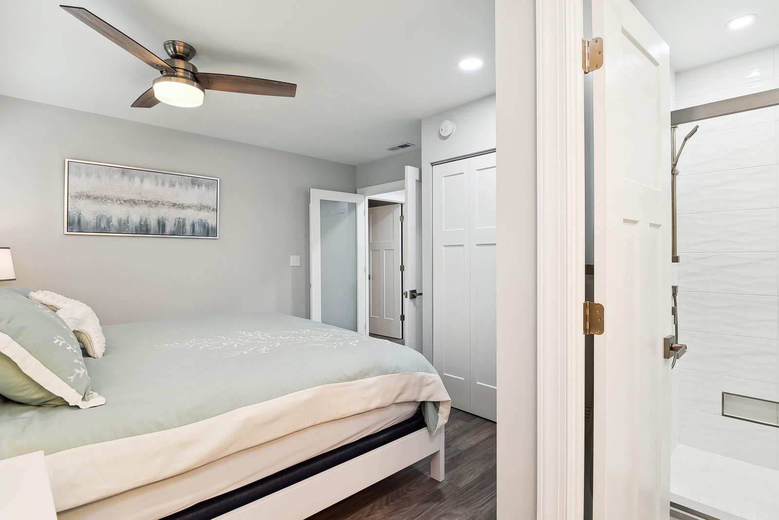 Your peaceful bedroom retreat features modern comfort and clean lines, with a ceiling fan to keep you cool and a private ensuite just steps away.