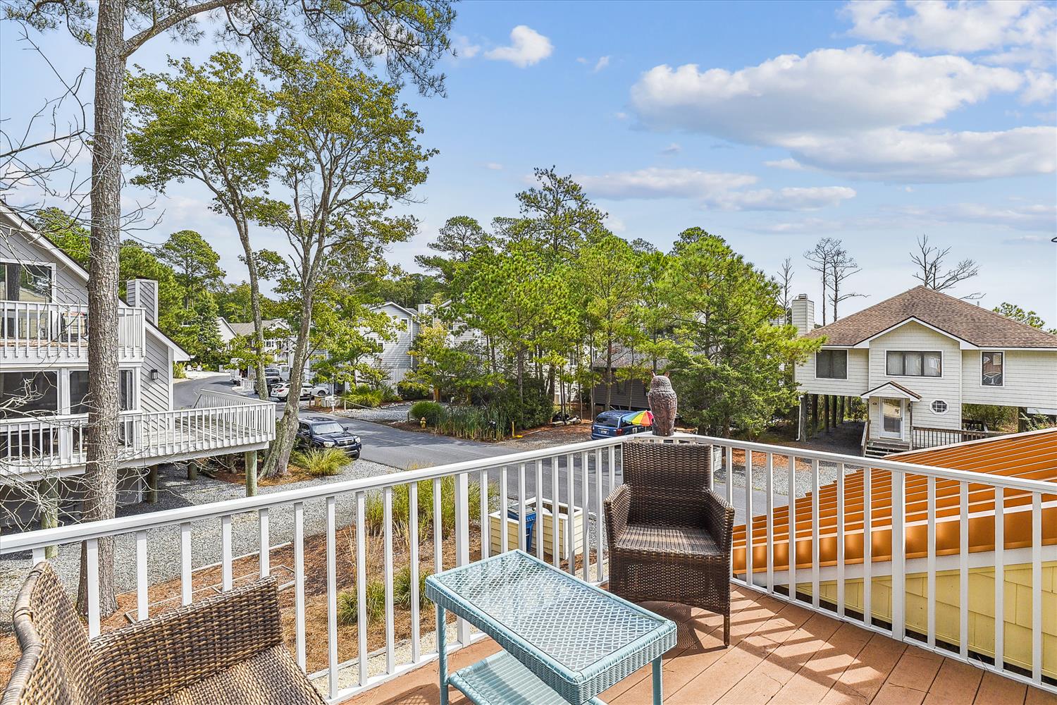 Step out onto your private balcony and settle into comfortable wicker seating surrounded by leafy trees and peaceful neighborhood views. Perfect for your morning coffee or evening unwinding.