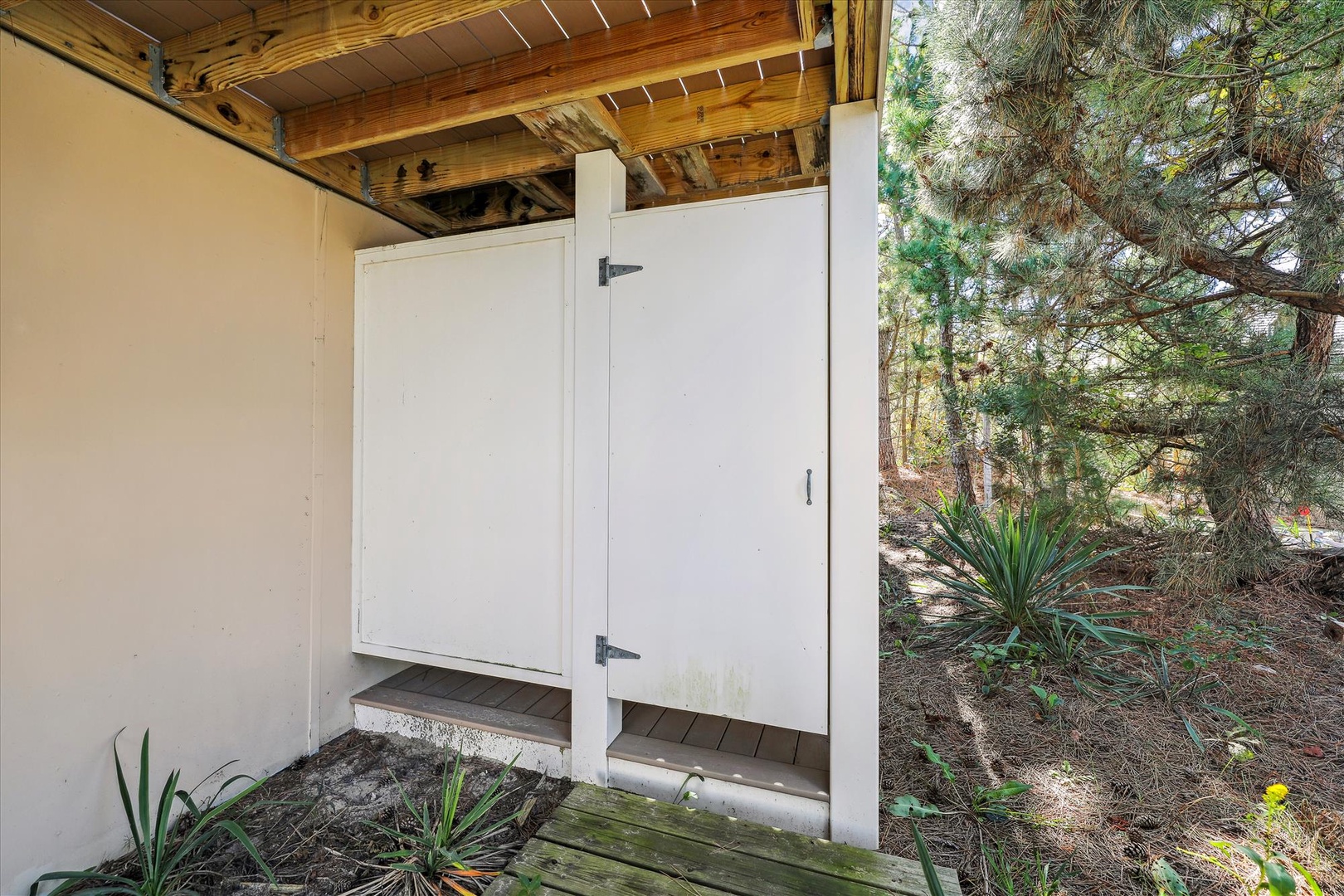 This property is surrounded by mature pines and natural landscaping, offering a peaceful wooded retreat for your stay.