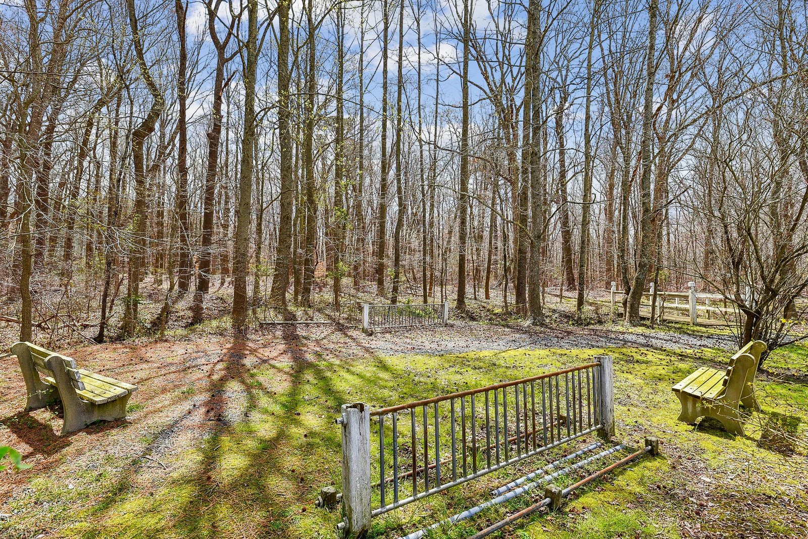 The property is set on a tranquil forested lot offering shade, fresh air, and peaceful wooded scenery. Outdoor seating areas provide a quiet place to unwind amid nature.