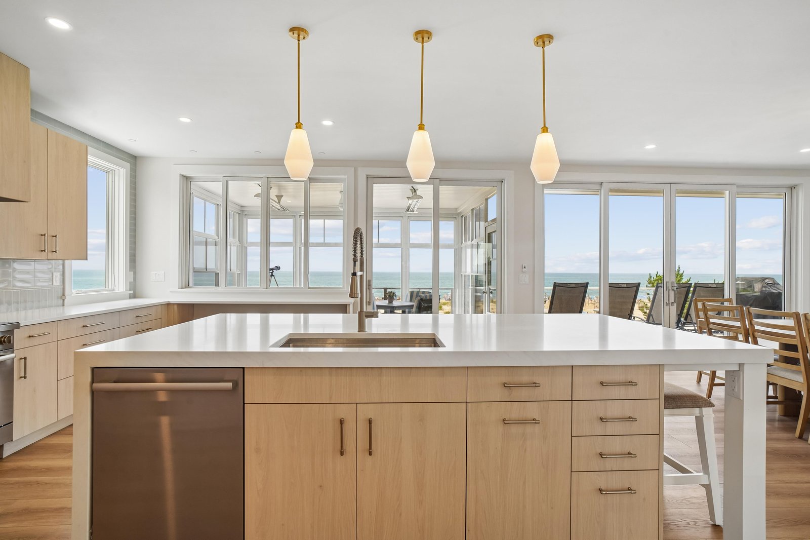 Watch the waves from your sleek kitchen with its spacious island and sparkling ocean views framed by floor-to-ceiling windows.