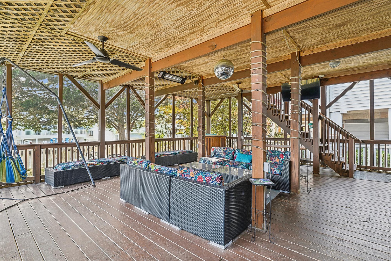 Step onto this spacious covered deck and settle into plush outdoor seating. Ceiling fans keep you cool as you unwind, while the hammock invites lazy afternoons overlooking lush, tranquil surroundings.