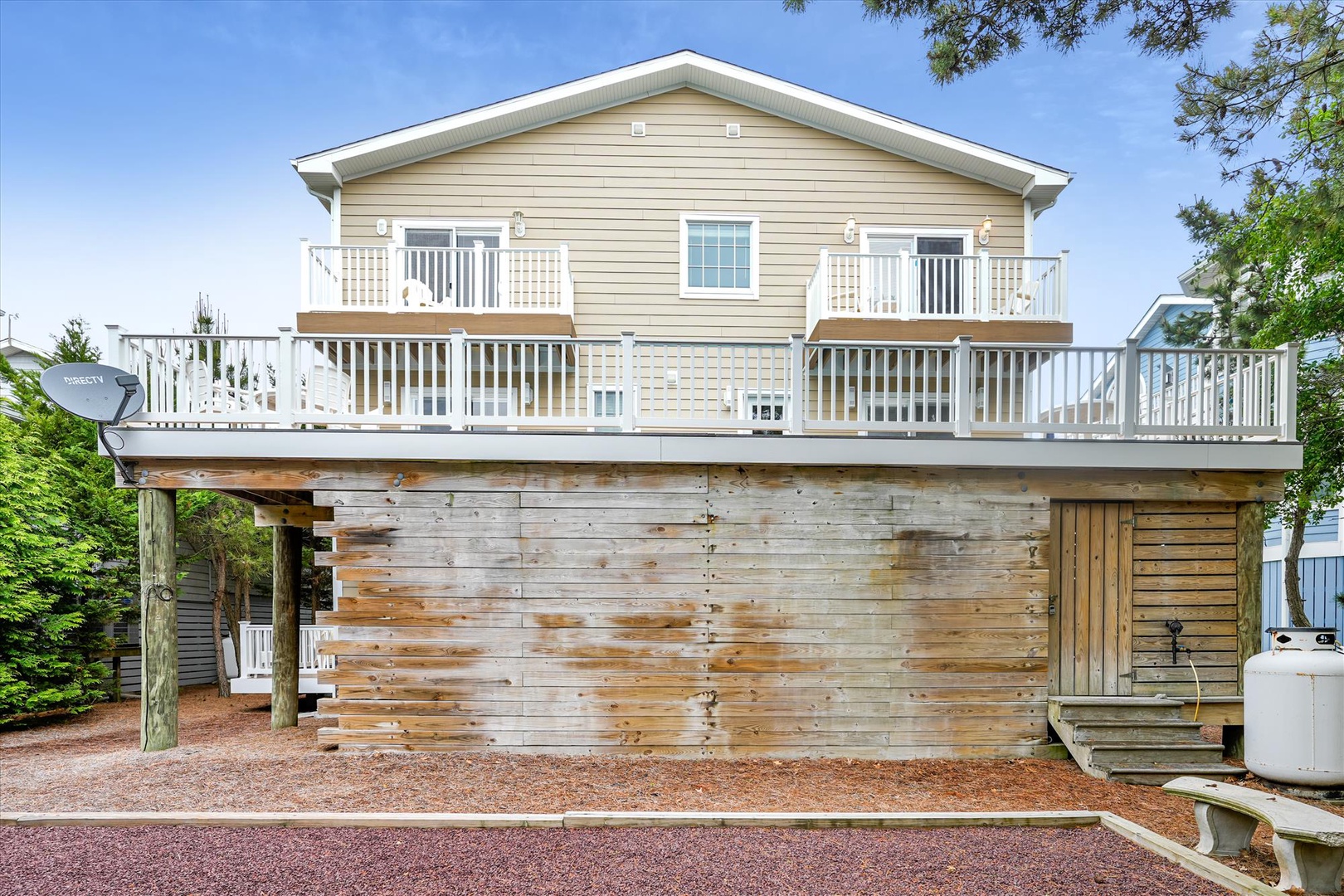 This welcoming beachside home features an elevated design with multiple decks and balconies, offering a perfect blend of coastal living and private outdoor spaces.