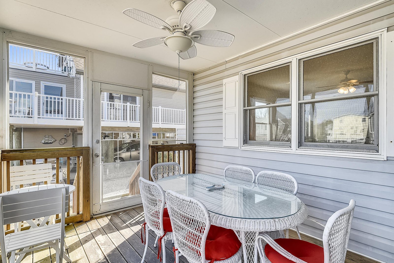 Your private screened porch awaits with comfortable seating for leisurely meals and relaxation. A ceiling fan keeps the breeze flowing while you enjoy outdoor living protected from the elements.