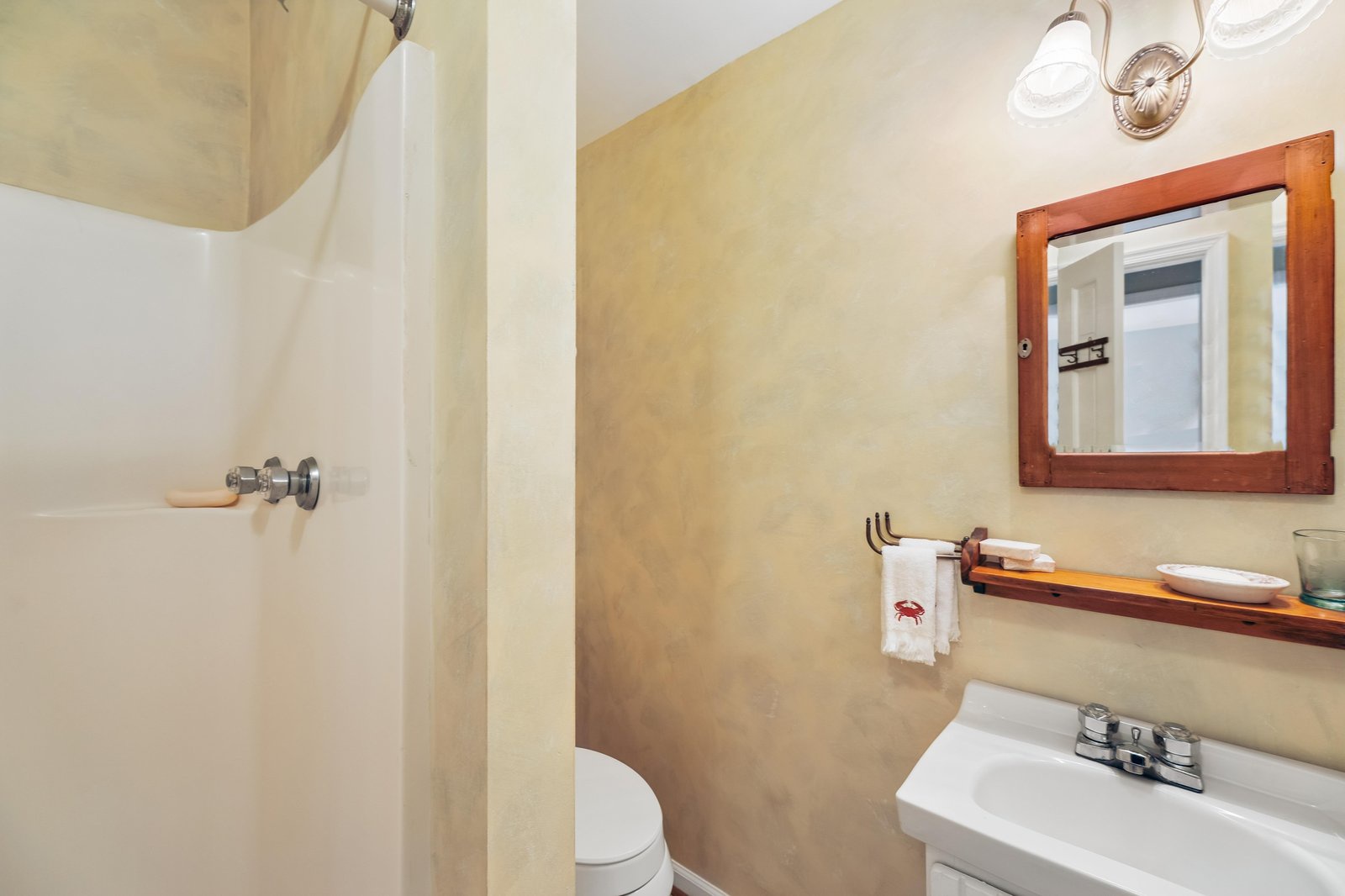 Your private bathroom offers everything you need to refresh and recharge, with soft towels, a refreshing shower, and warm lighting that makes the space feel inviting and calm.