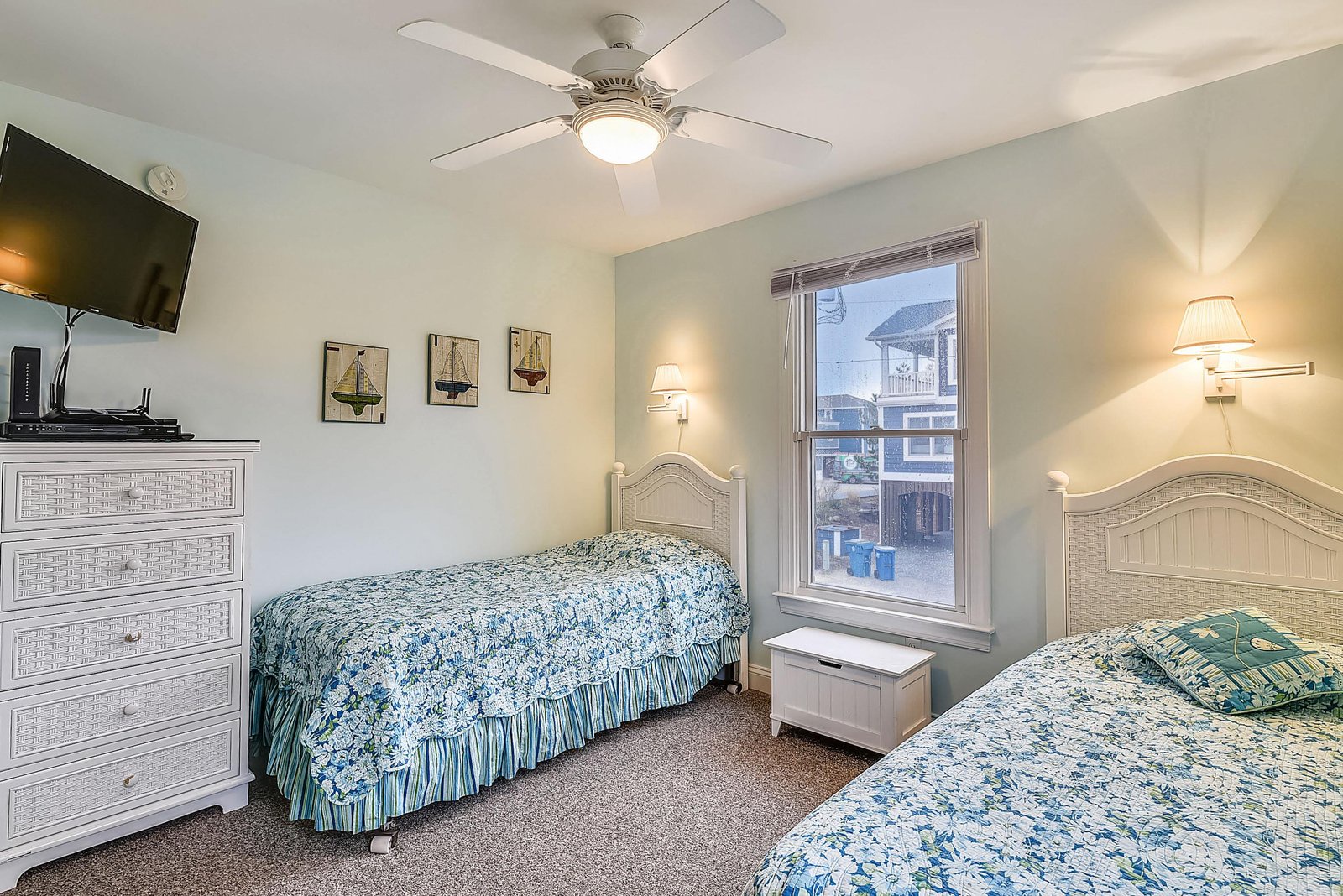 Relax in this comfortable bedroom with two cozy beds, soothing coastal décor, and soft lighting. The ceiling fan keeps you cool, while warm lamps invite peaceful evenings after a day of adventure.