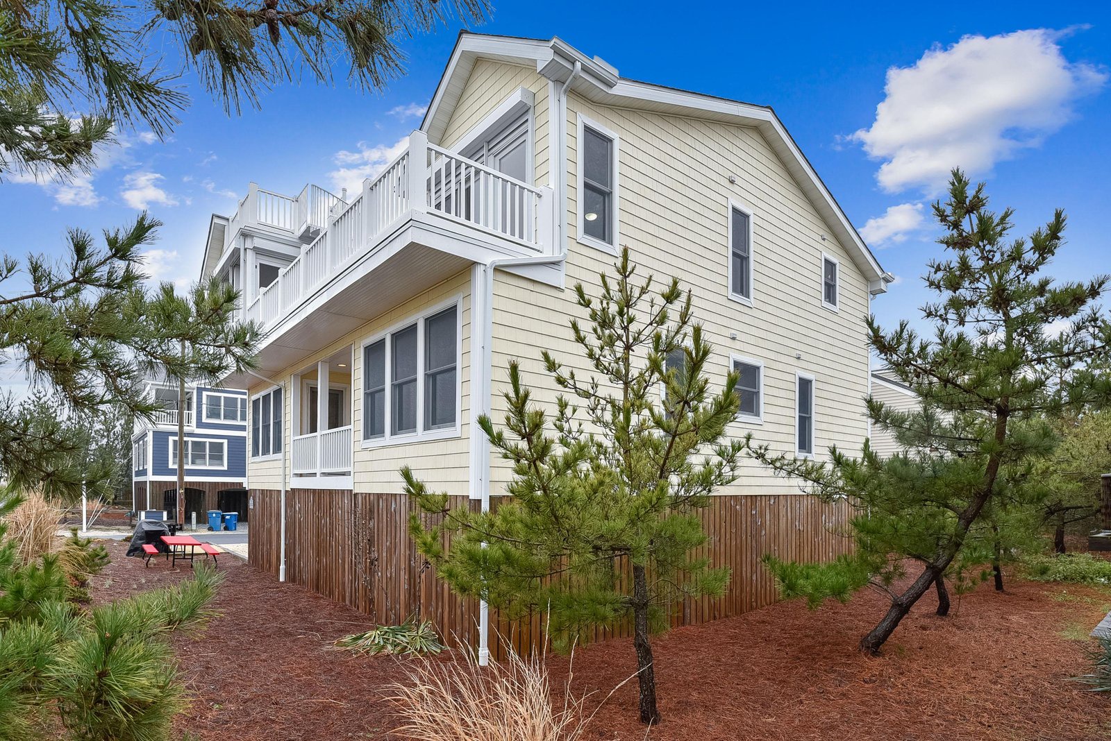 A coastal retreat framed by natural pines, where clean lines and airy balconies promise both privacy and peaceful surroundings.