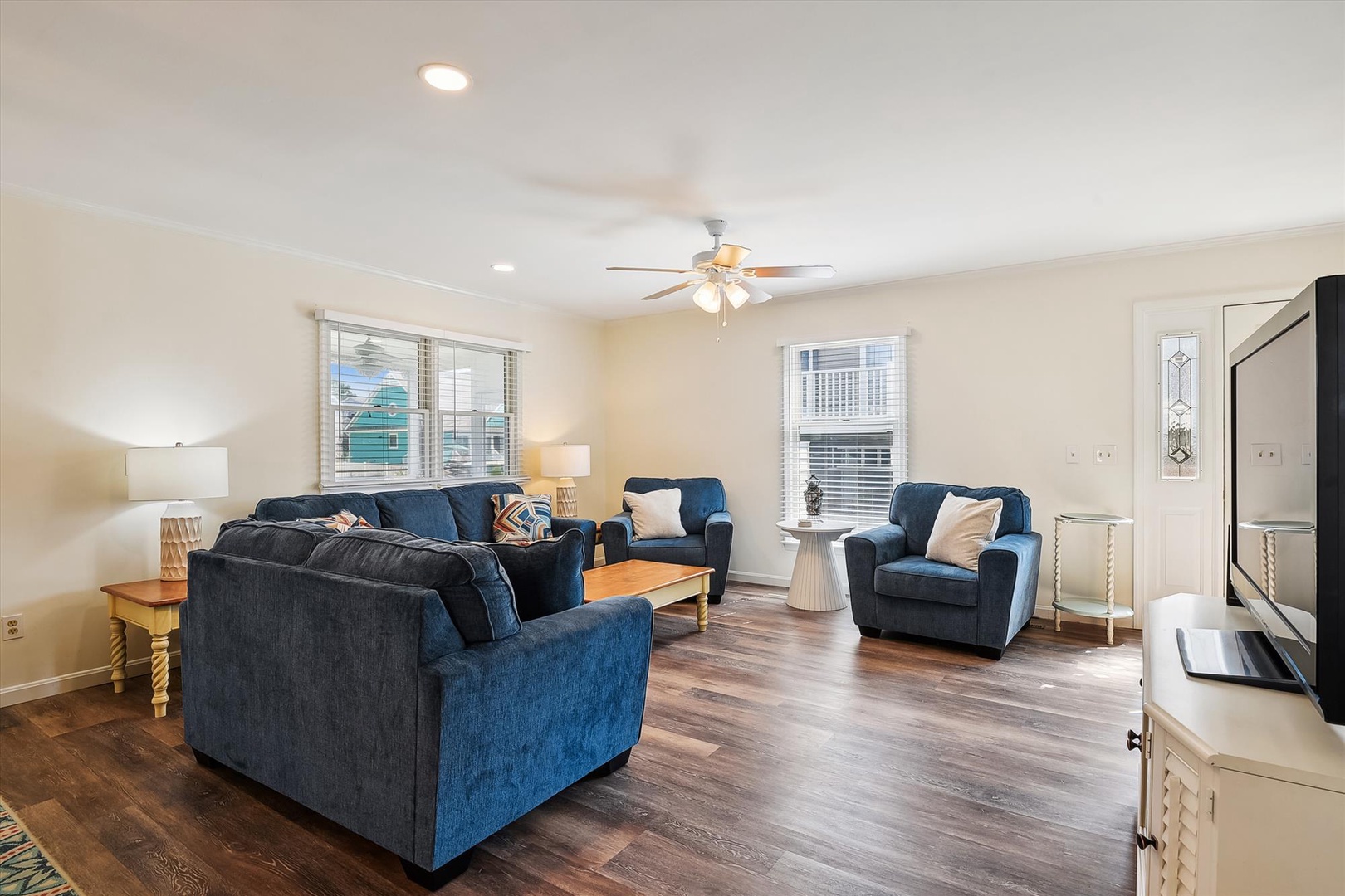 Picture yourself unwinding in this bright, spacious living room with plush seating and calming coastal charm—your perfect retreat after exploring nearby beaches.