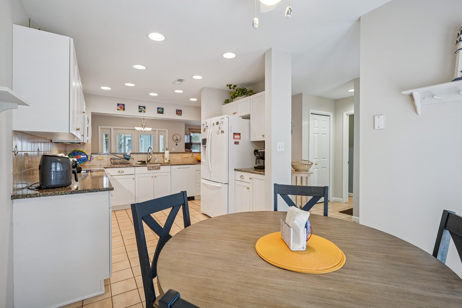 Gather around this spacious dining table that flows into your fully equipped kitchen, where bright natural light and modern appliances make meal prep effortless and enjoyable.