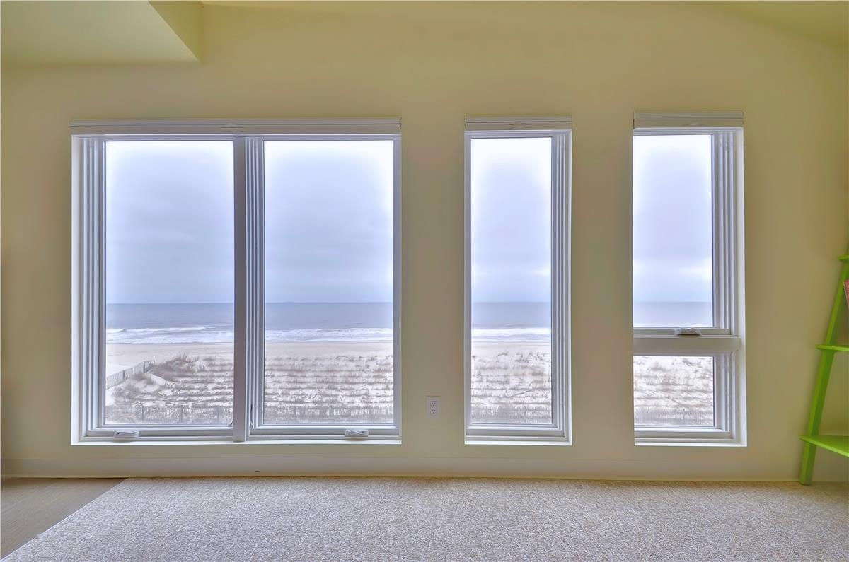 This bright, open room frames sweeping ocean views that stretch beyond the dunes and wild grasses. Picture yourself waking to the sound of waves or simply gazing out at the endless horizon whenever you need a peaceful moment.